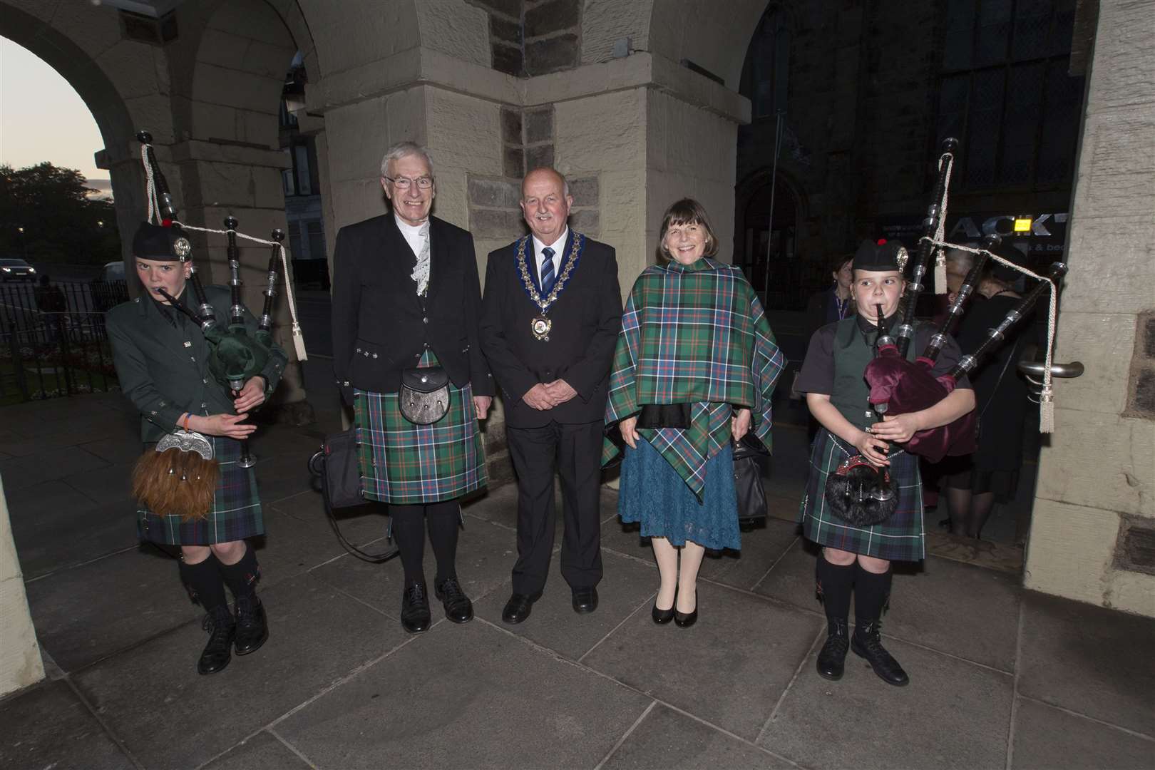 The Rt Rev Colin Sinclair and his wife Ruth are welcomed to a civic reception in Wick Town Hall by civic leader Councillor Willie Mackay and young pipers Glenn and Morven Miller, from Watten. Picture: Robert MacDonald / Northern Studios