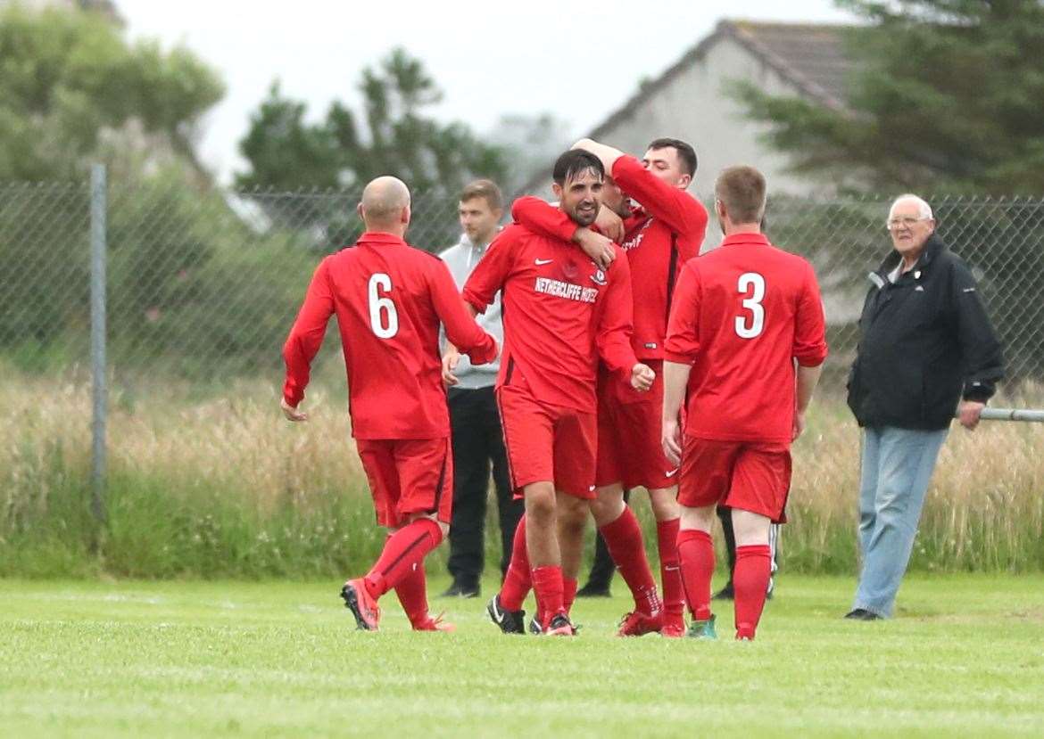 Graham MacNab (centre) is congratulated on scoring Wick Groats' second goal in the top-of-the-table clash with Pentland United last week. MacNab was again on target versus John O'Groats as the county champions moved closer to retaining the title. Picture: James Gunn