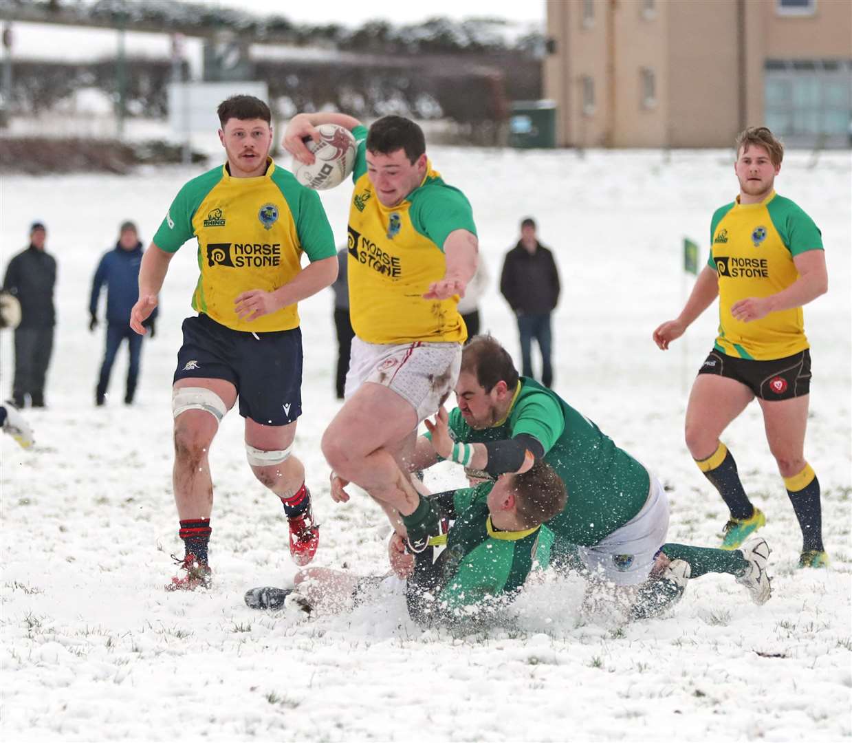 Jordan Miller is tackled by two Caithness players. Picture: James Gunn