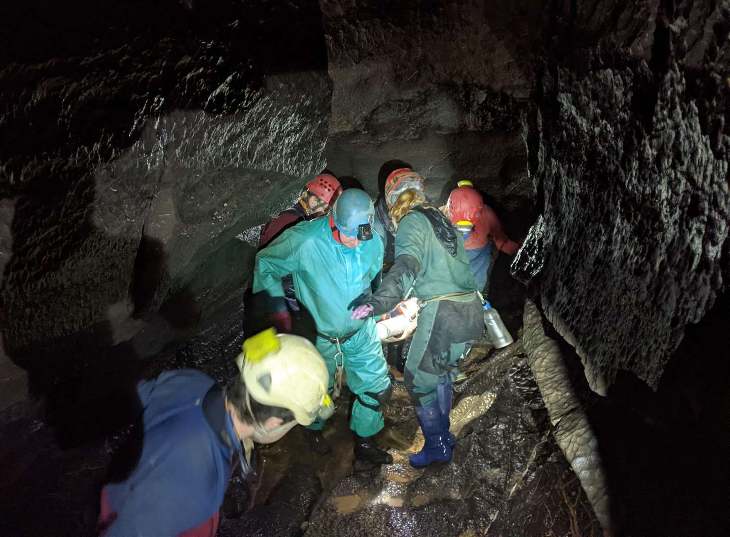 Rescuers carry George Linnane on a stretcher through the cave to safety (South & Mid Wales Cave Rescue Team/PA)