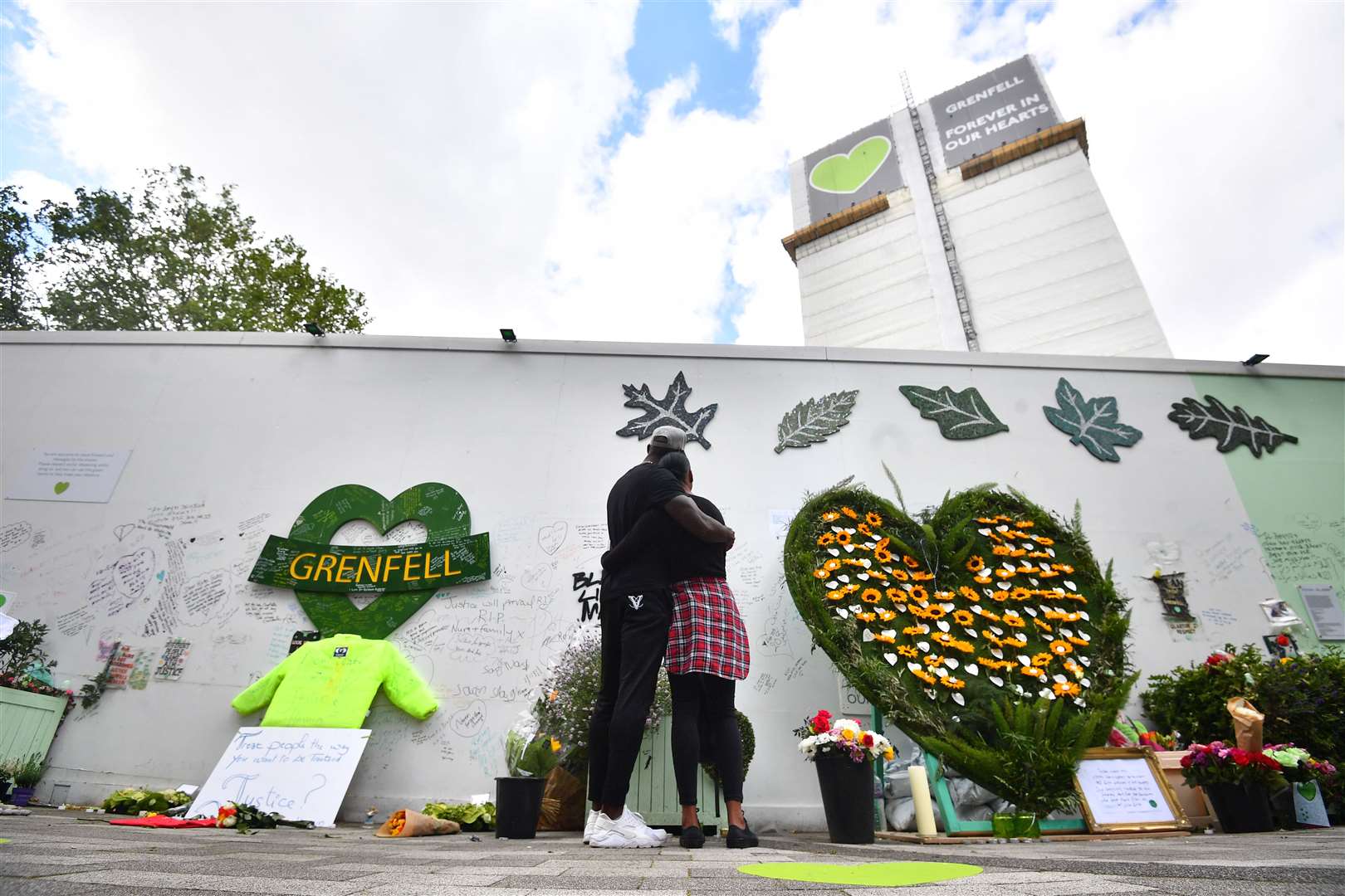 People at the Grenfell Memorial Community Mosaic (Victoria Jones/PA)