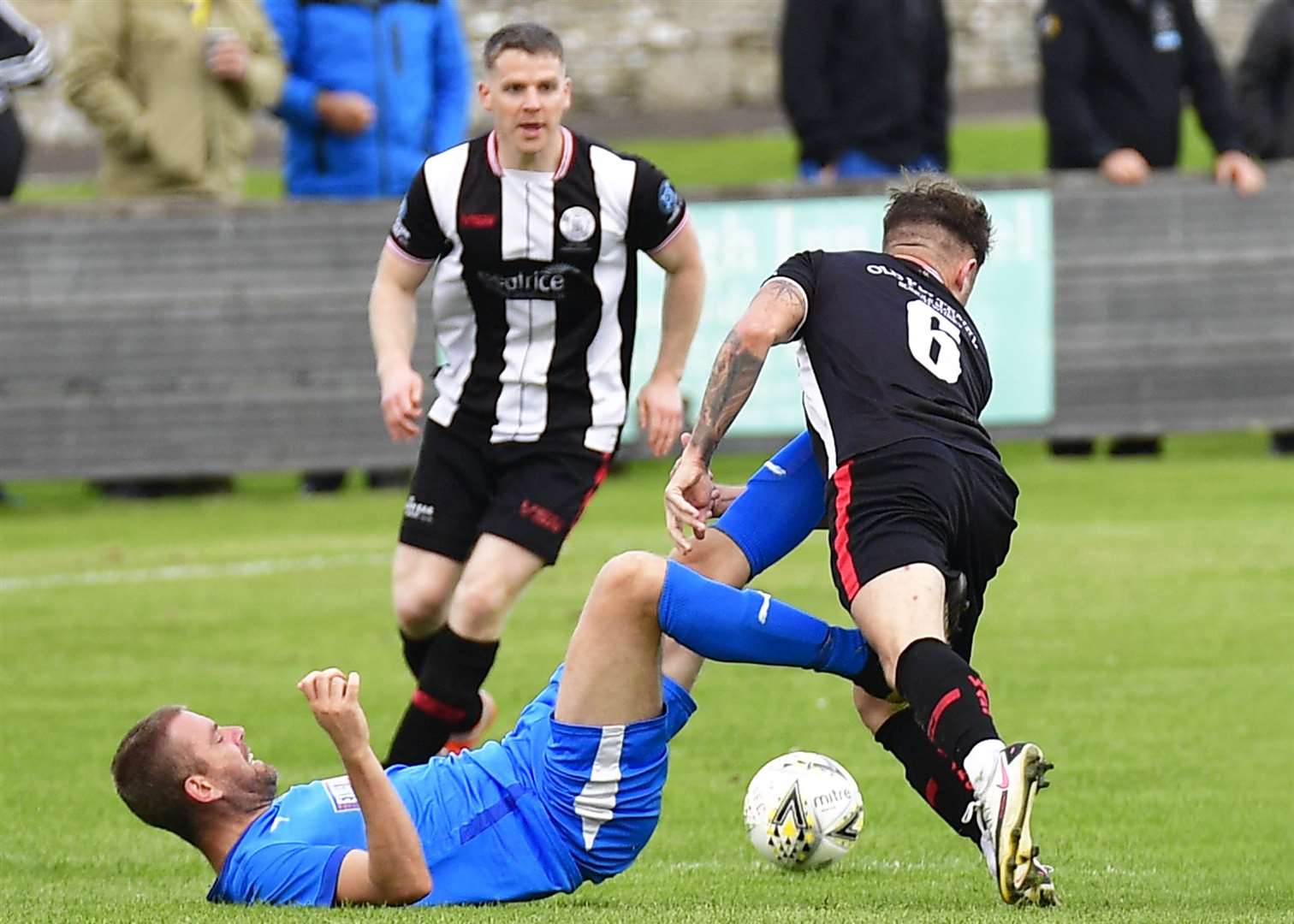Bo'ness United's Stuart Hunter has both feet up as he fouls Wick Academy's Jack Henry. Picture: Mel Roger