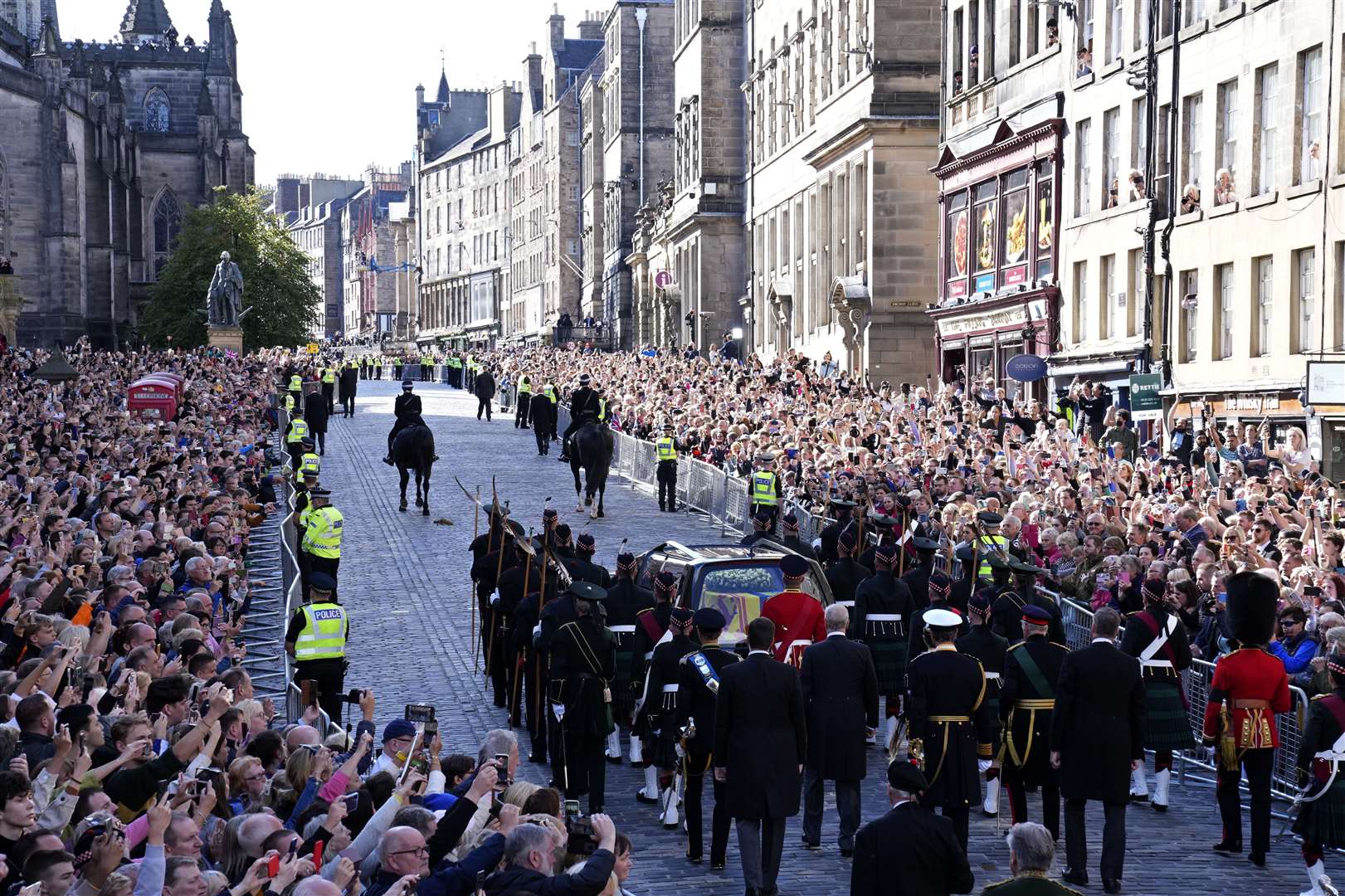 Sombre crowds lined the route as the hearse bearing the Queen’s coffin, followed by members of the royal family on foot, made its way up the Royal Mile, Edinburgh, in September (Jon Super/PA)