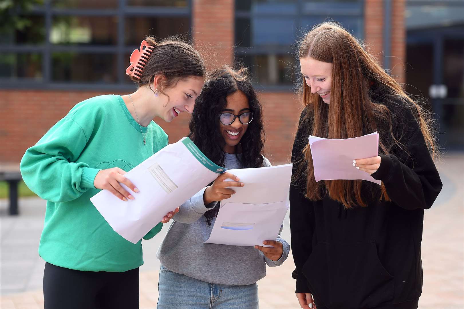Pupils at Our Lady and St Patrick’s College in east Belfast read their results (Oliver McVeigh/PA)