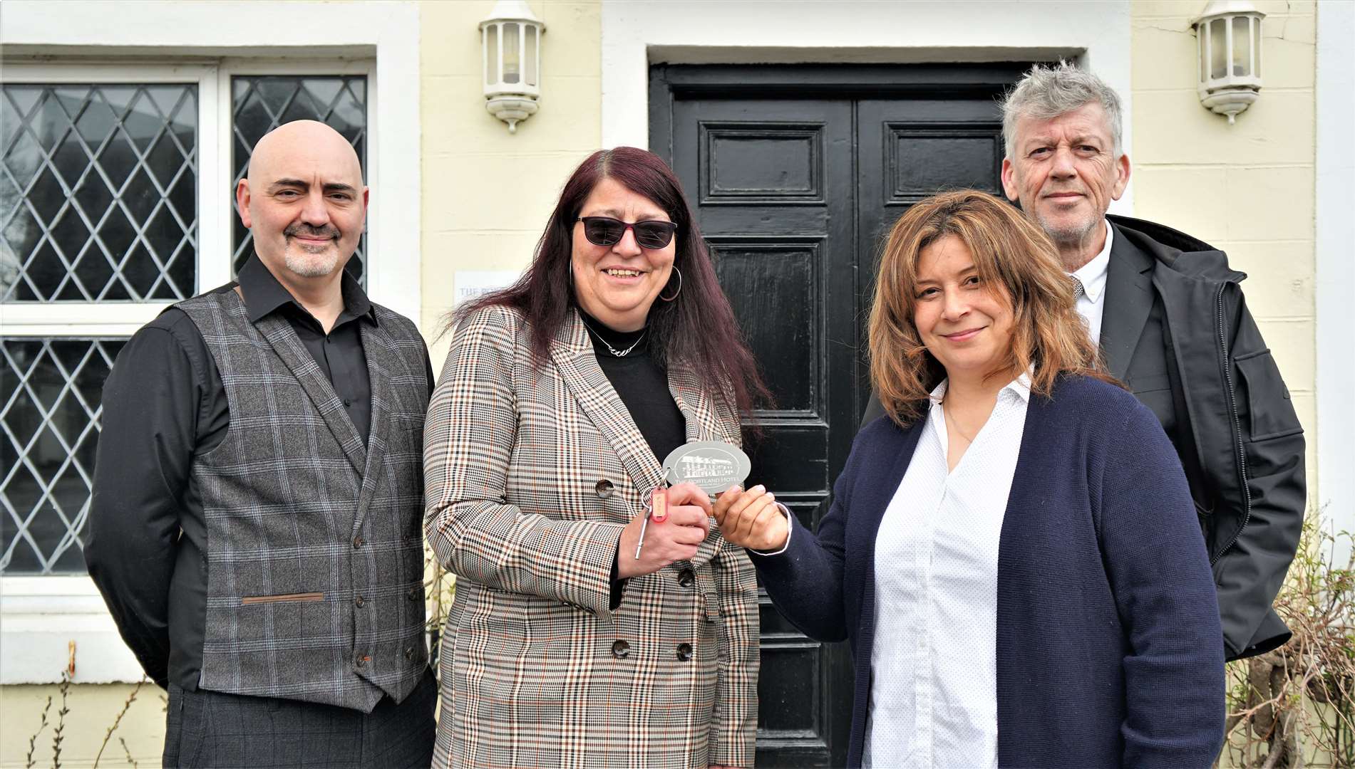 Previous owners of the Portland Hotel Steven Swan and his sister Sharn, at left, hand over the hotel keys to Jeff Harling and his wife Sam Mofttah. Picture: DGS