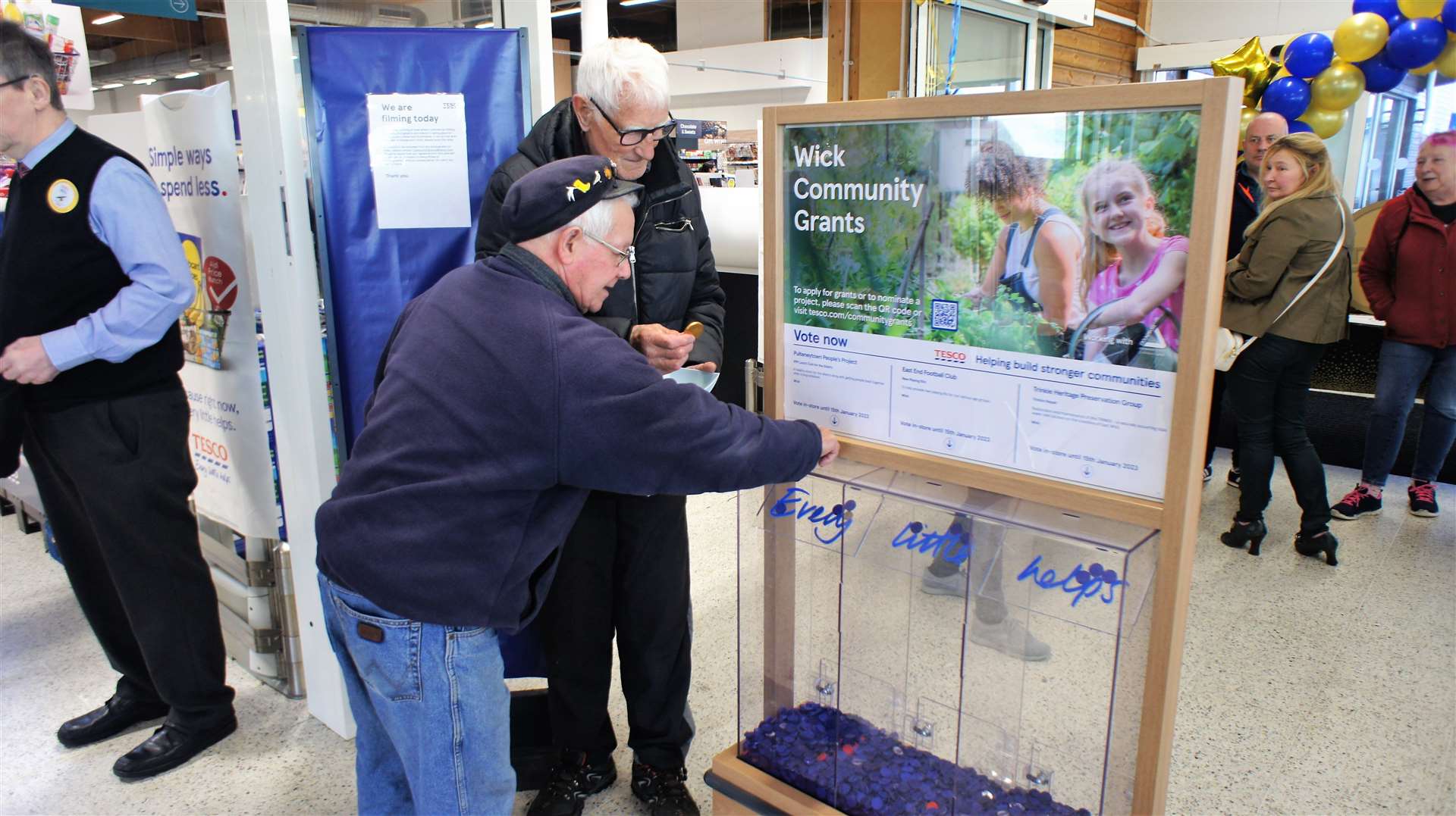 John Manson from Scrabster was just one of many who took part in the lucky dip. John places his blue token in the charity box while Denny Swanson, who helped out on the day, looks on. Picture: DGS
