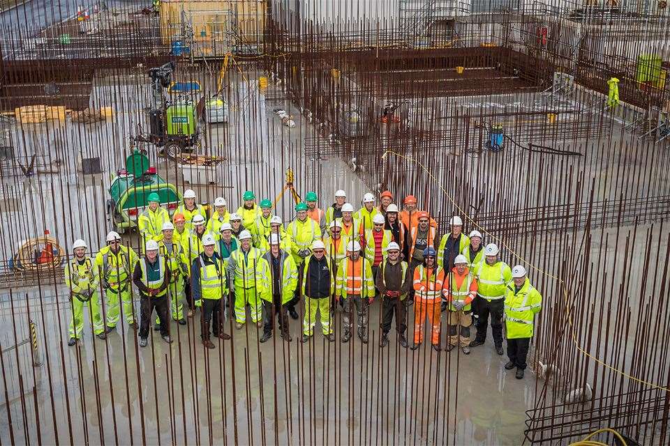 The team and members of the senior management pictured before the final concrete pour begins.
