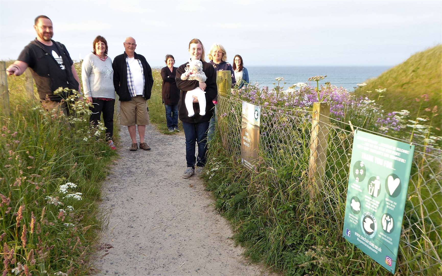 Sinclair's Bay Trust board members pictured from left at Reiss beach are Ian Ross, Pat Ramsay, Grant Ramsay, Maysie Calder, Christina Calder (with baby Isla), Maria Aitken and Emma Fraser. Missing from the photo are board members Andrew Mackay and Lynsay Rosie. Picture: DGS