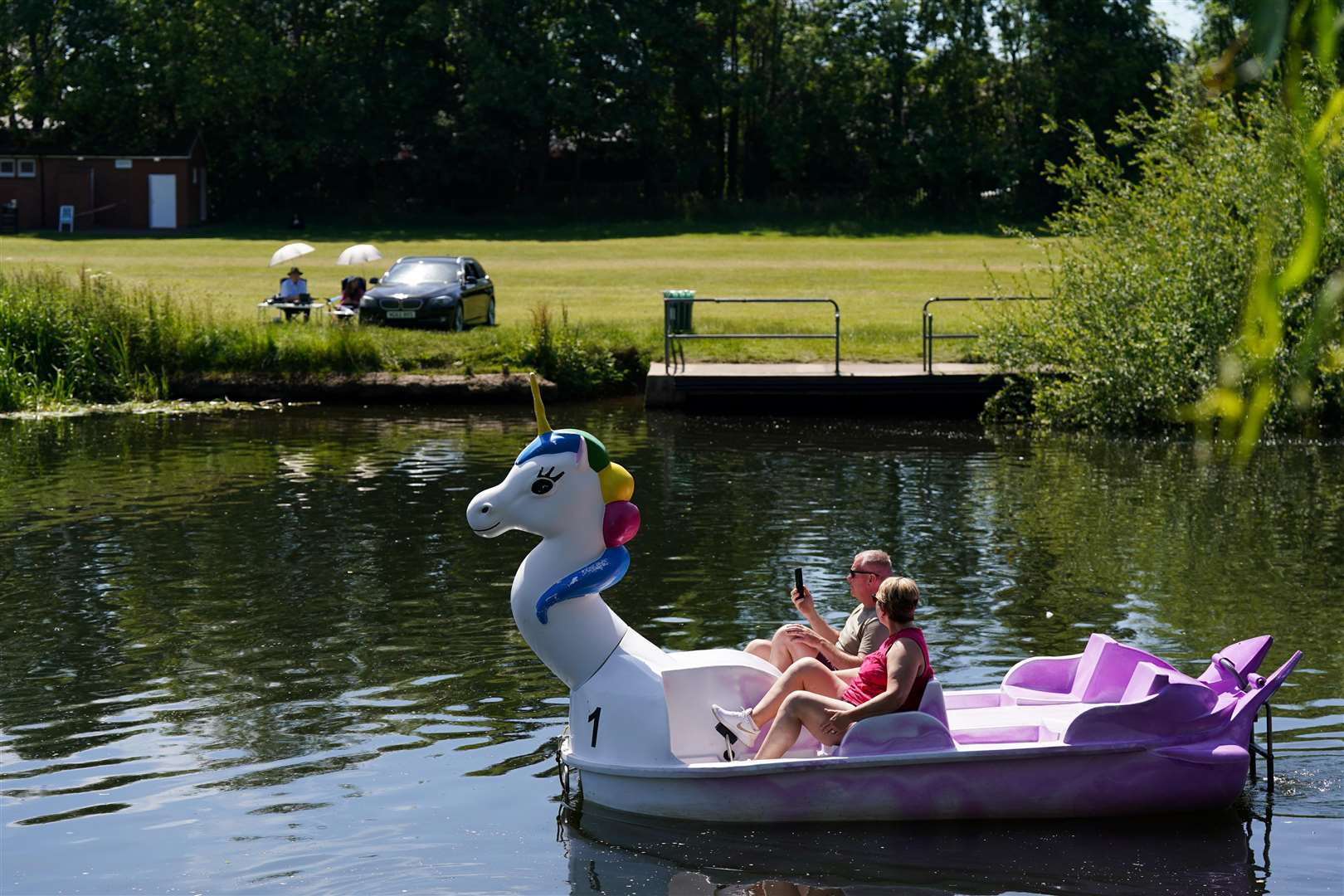 A couple enjoy the warm weather with a pedalo trip on the River Avon in Warwick (Jacob King/PA)