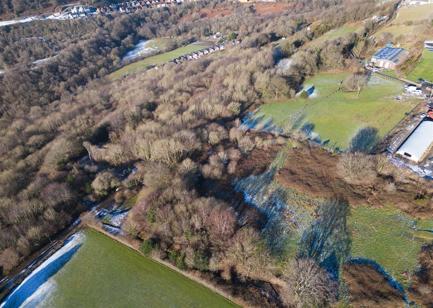 The woodland through which the leachate flowed, from the landfill in the bottom right to a road by the houses (Andrew Matthews/PA)