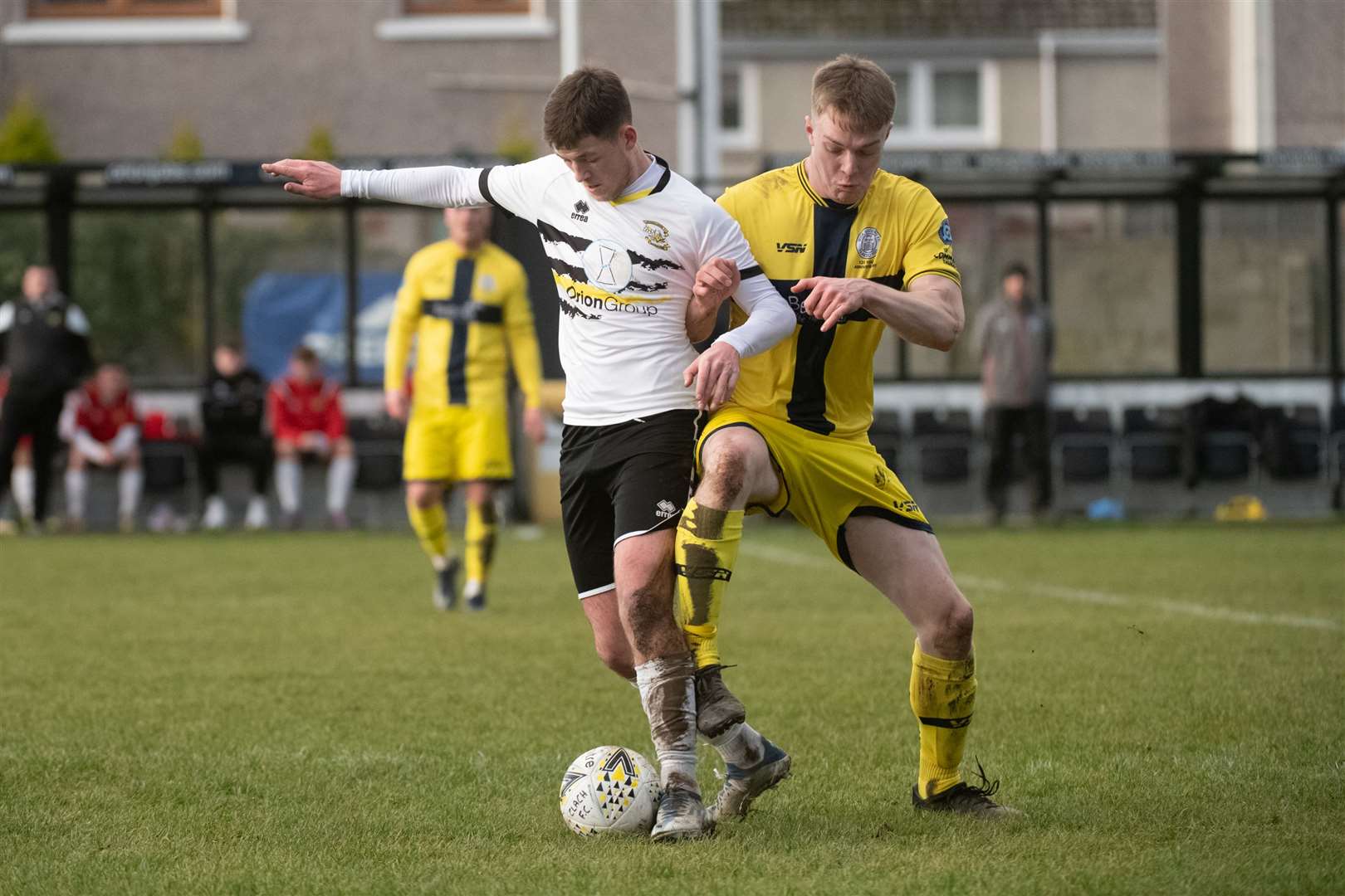 Alasdair Gillies (Clach) comes under pressure from Wick Academy's Jamie Flett. Picture: Callum Mackay