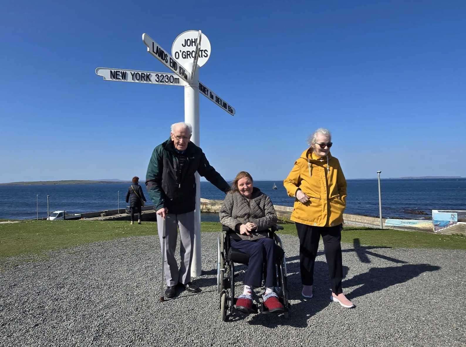 Alexander Budge, Barbara Thomson and Catherine Foubister pose at the famous Groats sign.
