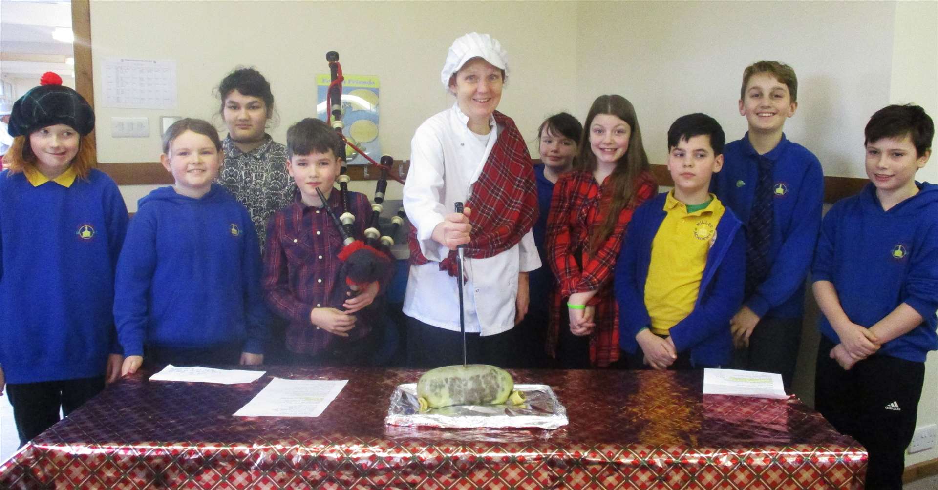 Miller’s cook Roseanda Miller with the children who recited the Address to a Haggis, along with the piper.
