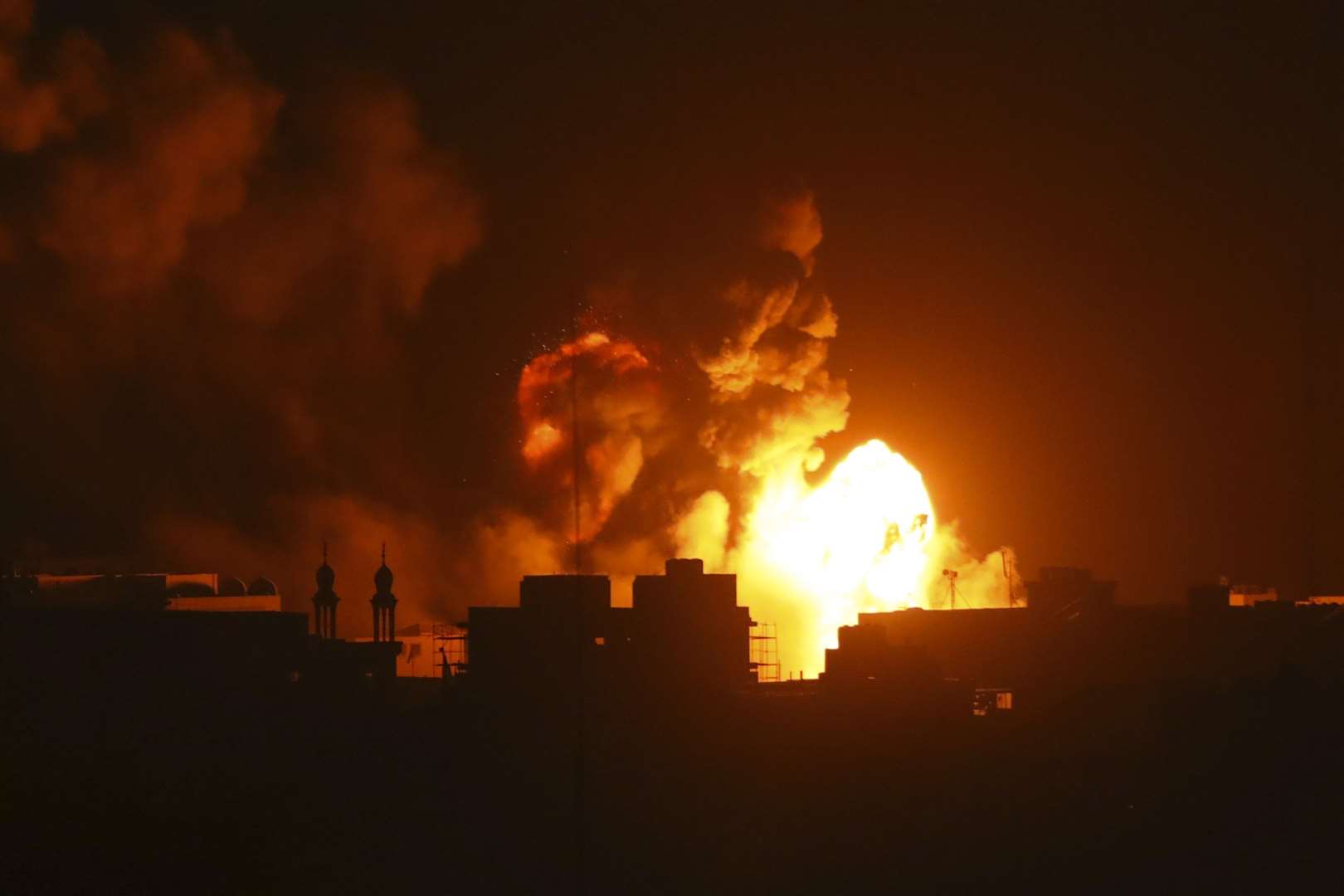 Fire and smoke rises from buildings following Israeli airstrikes on Gaza City on Sunday (Abed Khaled/AP)