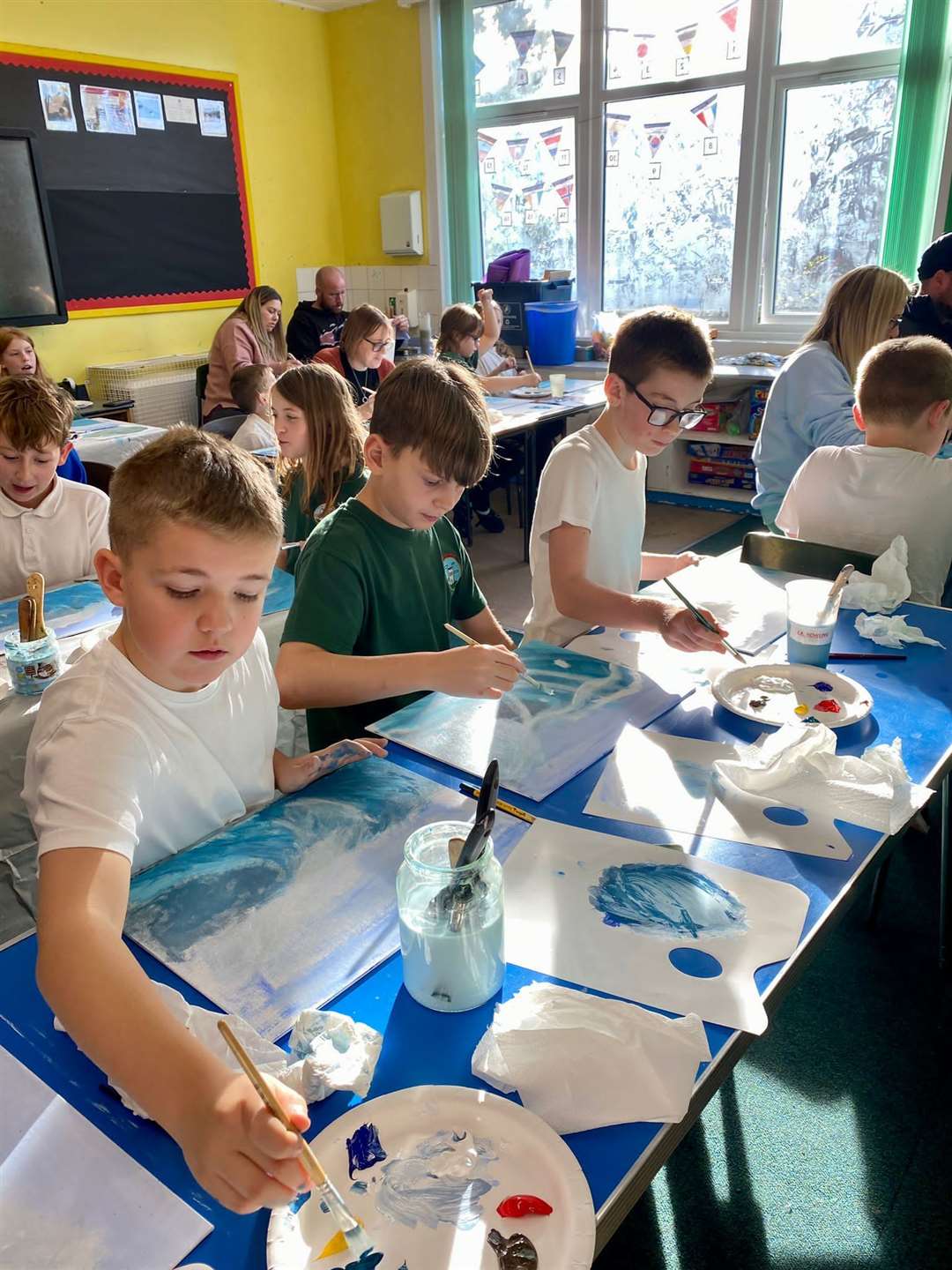 Some of the P5-P7 youngsters concentrating on their wave paintings.