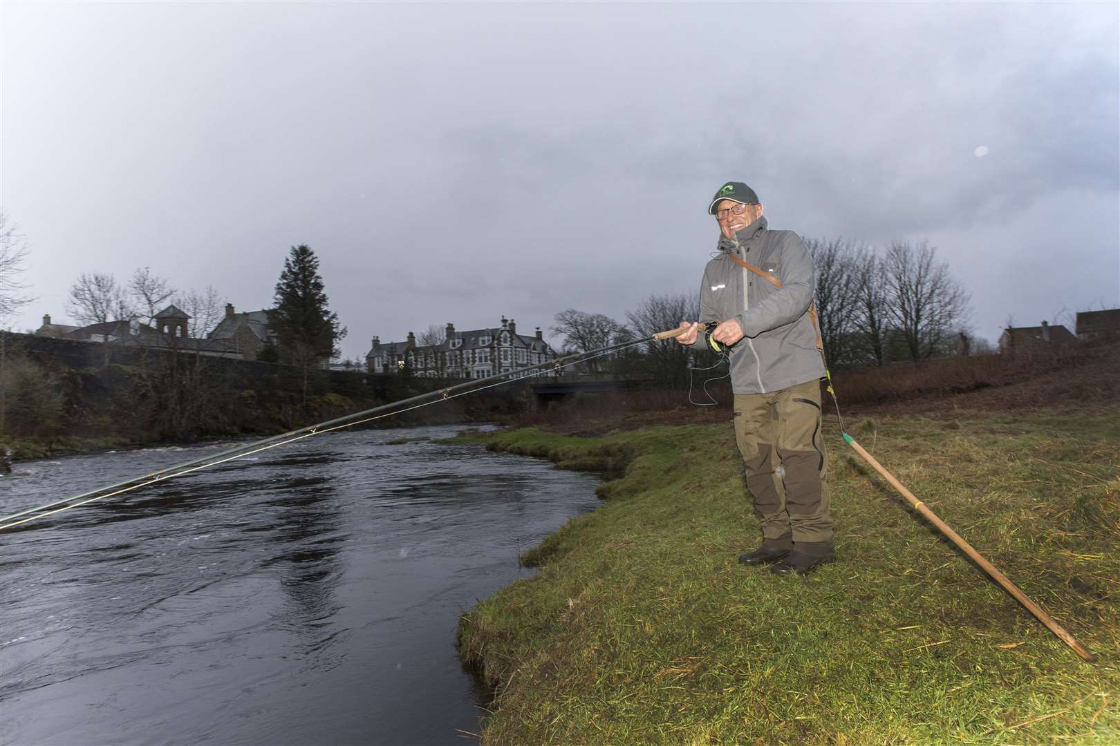 In damp and dull conditions on Saturday morning, 81-year-old retired landscape garden Freddie Sutherland, from Uddingston, casts the first fly of the new salmon season on the River Thurso. Picture: Robert MacDonald / Northern Studios