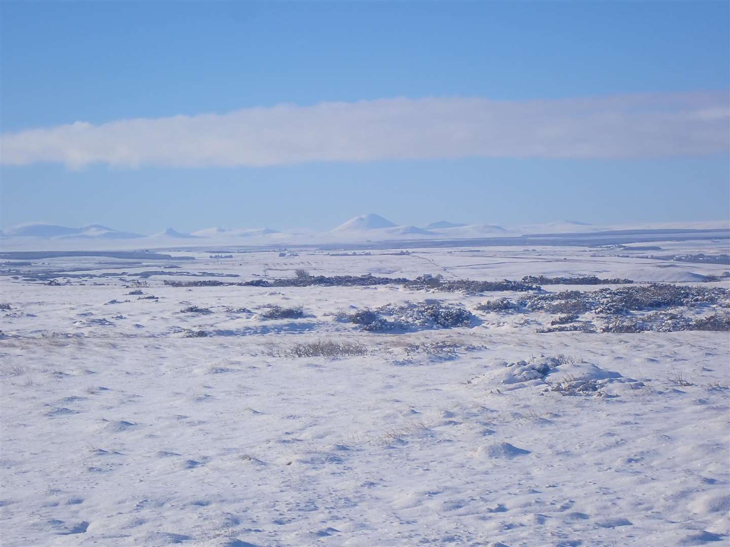 The hills of the far north are outlined in stark relief in the bright snow and shadows.