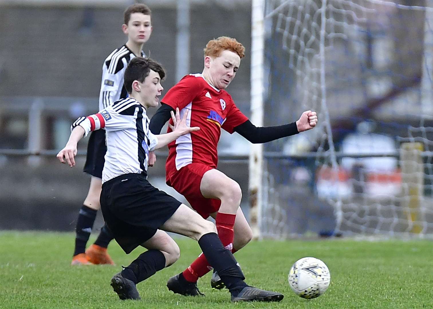 Aidan Miller of Wick Academy under-15s challenges Do Soccer's Ross Nicol. Picture: Mel Roger