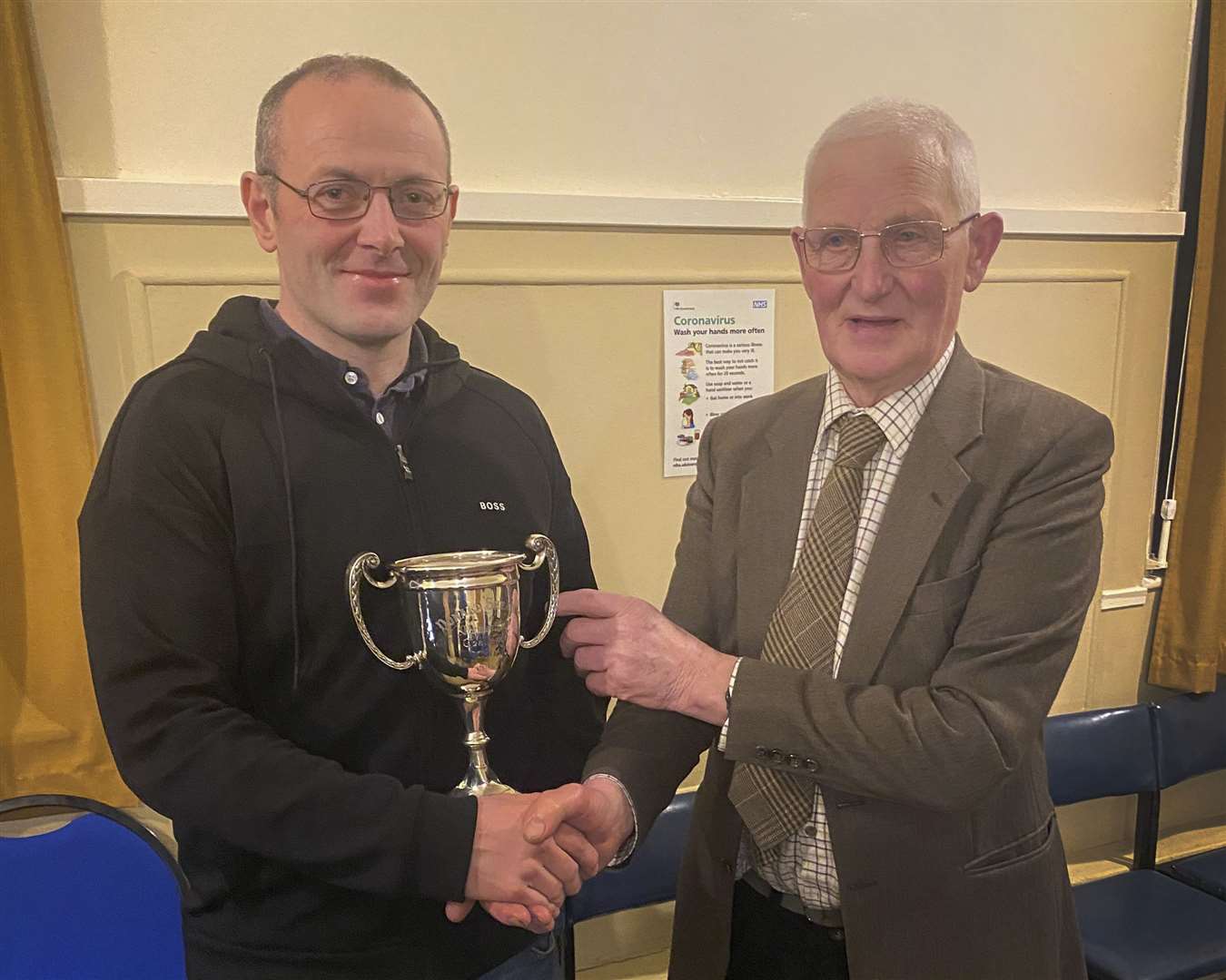 David Simpson (left) receiving Caithness Small-Bore Rifle Association's Shearer Cup from Jim Manson. Picture: Robert MacDonald / Northern Studios
