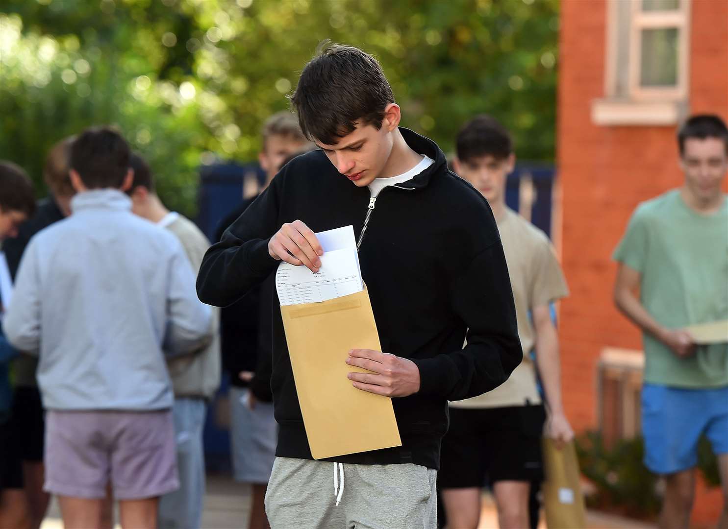 Pupils at Sullivan Upper School in Holywood, Co Down, check their results (Oliver McVeigh/PA)