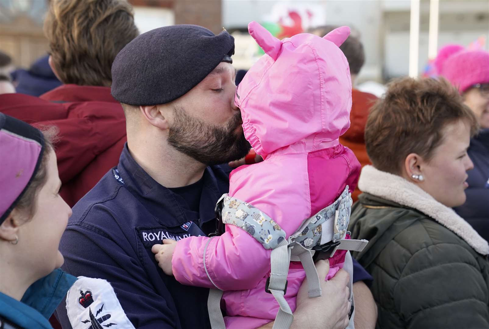 Petty Officer Nicholas Baker holds his daughter Amelia-Rose (Andrew Matthews/PA)