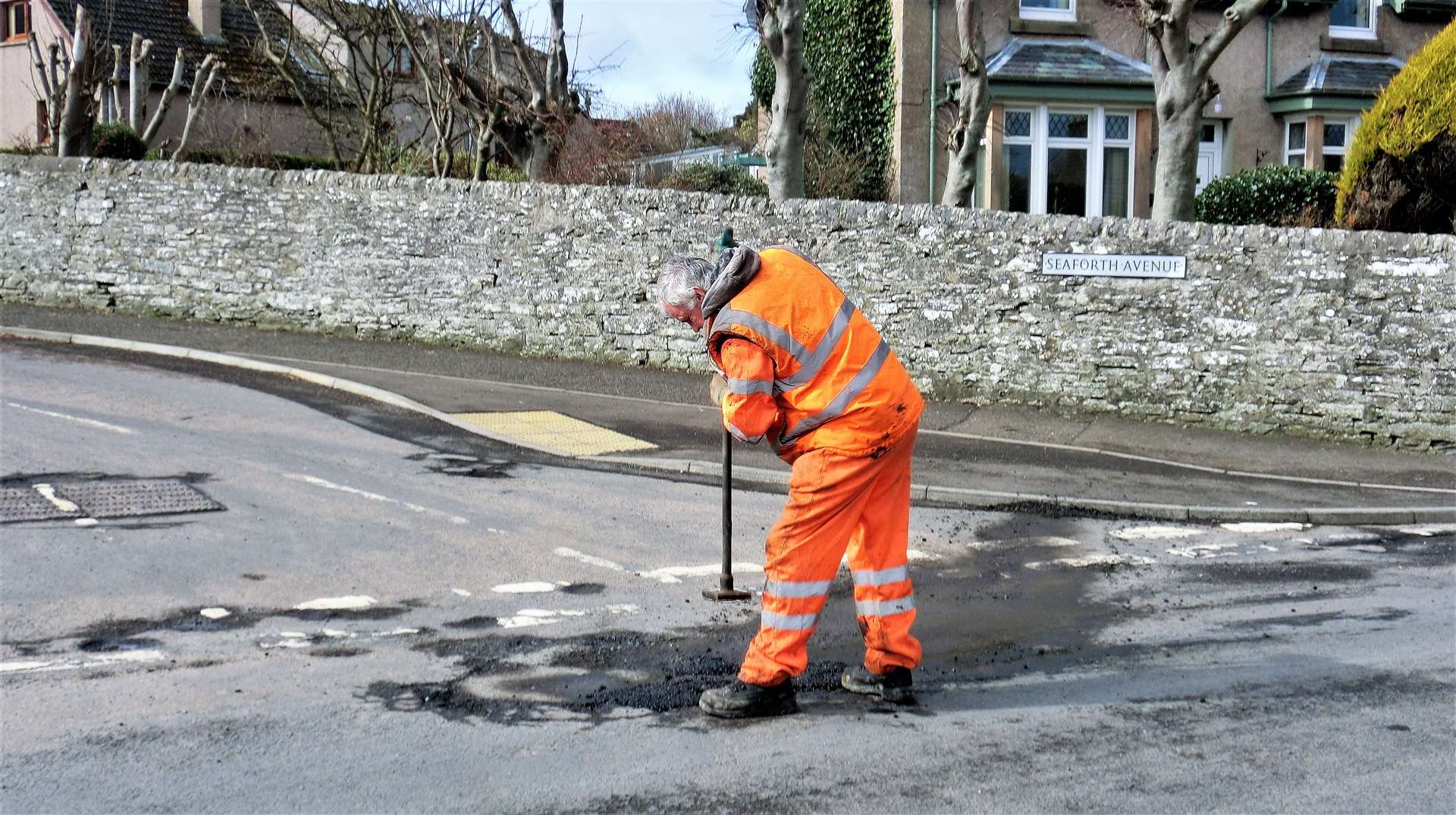 Council worker seen recently fixing a pothole at West Banks Avenue in Wick with a cold patch. Picture: DGS