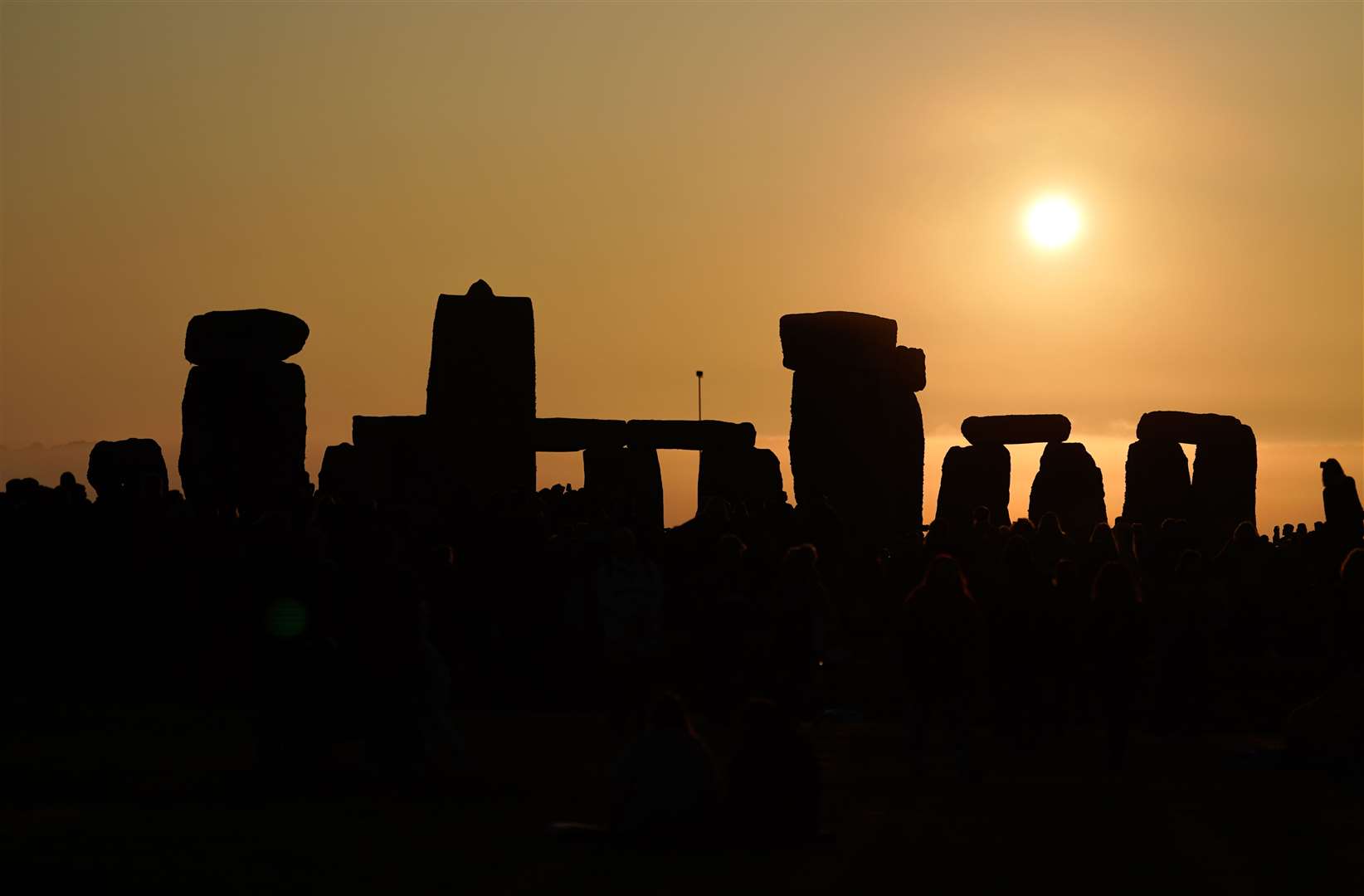 The sun rises behind the stone circle (Andrew Matthews/PA)