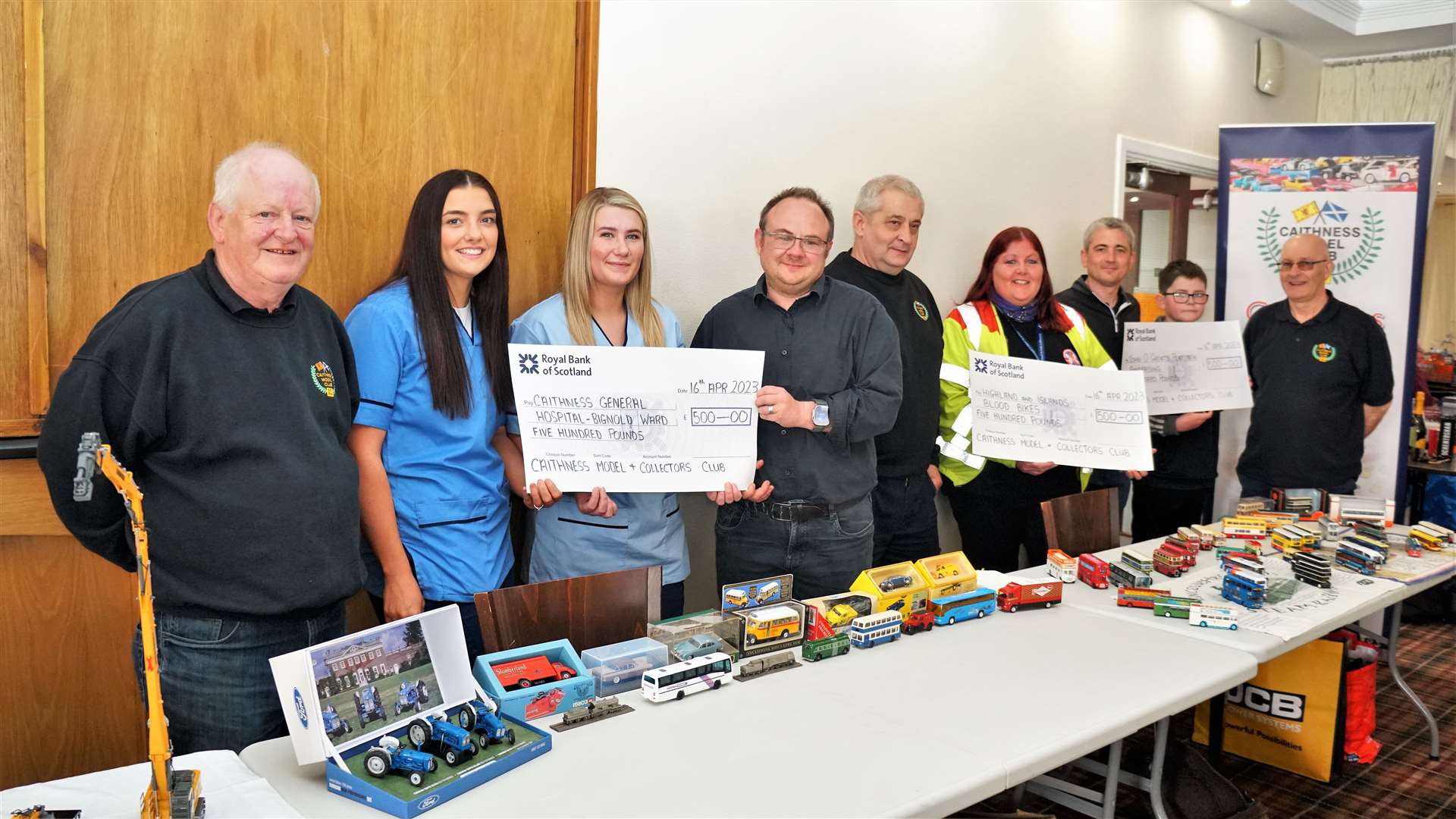 Charity cheques handed out to the good causes at the Caithness Model Club (CMC) show on Sunday. From left, Davie Mackenzie (CMC show manager), Paige Addison (NHS), Molly Todd (NHS), Stephen Makin (NHS), Andrew Anderson (CMC), Pamela Johnson (Blood Bikes), Willie Ross and his son Michael (John O'Groats Playpark) and Kenny Gunn CMC chair. Picture: DGS