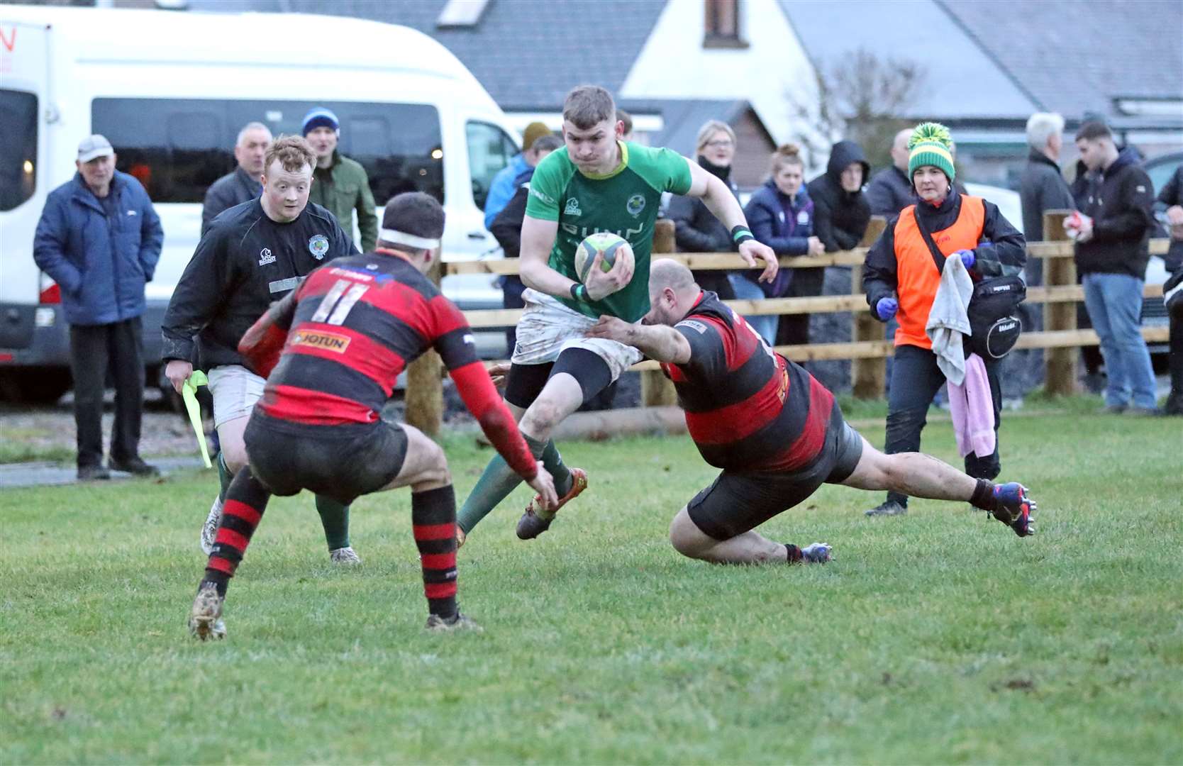 Drew Mathieson of Caithness is tackled wide on the right wing. Picture: James Gunn