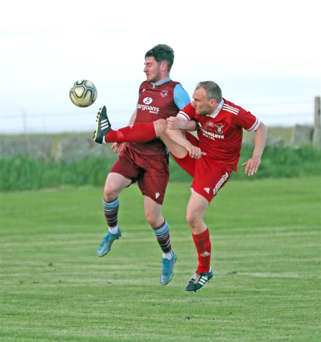 Wick Groats defender Gavin Sinclair kicks the ball clear from Pentland United forward Conor Cormack. Picture: James Gunn
