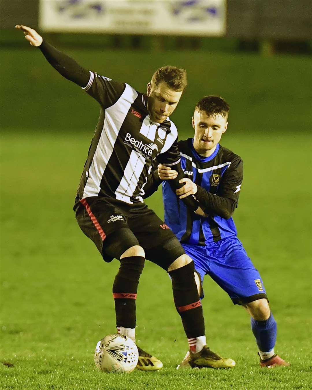 Wick Academy's Craig Gunn fends off Reece McKeown during last Saturday's 3-0 cup defeat to Huntly. Gunn, who is top scorer for the Scorries this season, is carrying a niggling injury and will have hit fitness assessed ahead of this weekend's game against Fraserburgh. Picture: Mel Roger