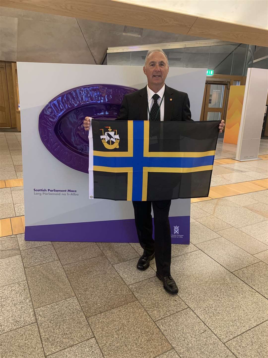 Billy Sinclair with the Caithness flag at the Scottish Parliament this week