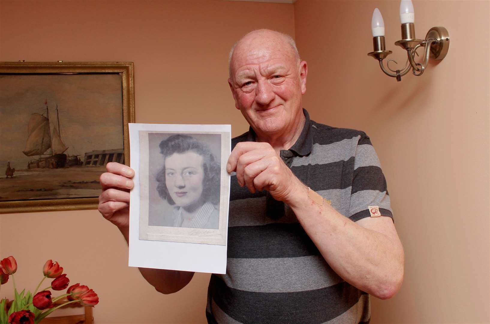 Iain Gregory holding a photo of his mother, Emily. Picture: Alan Hendry