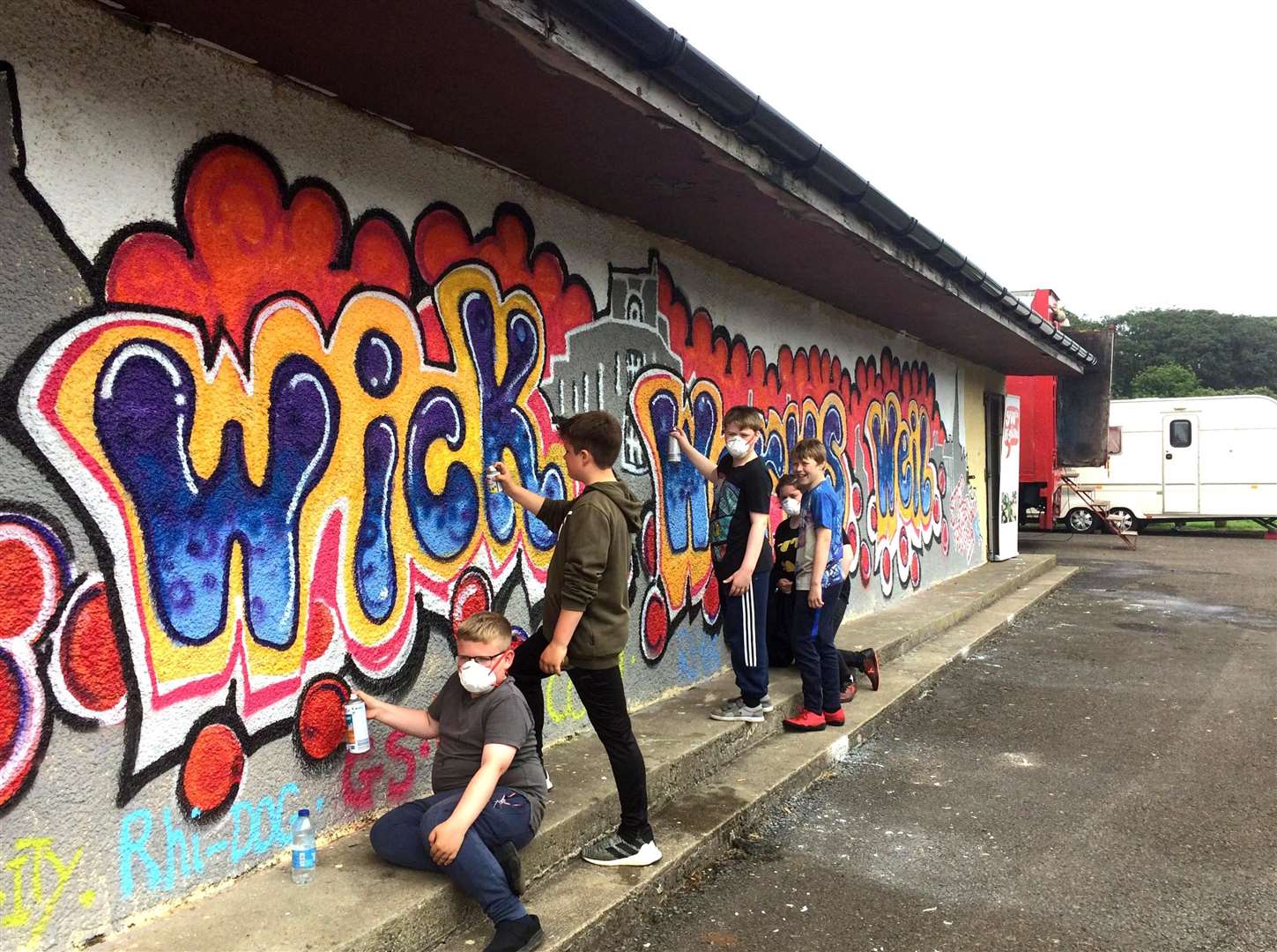 A team of local youngsters creating a new mural at Wick riverside boating shed. Picture: Anderina Cass