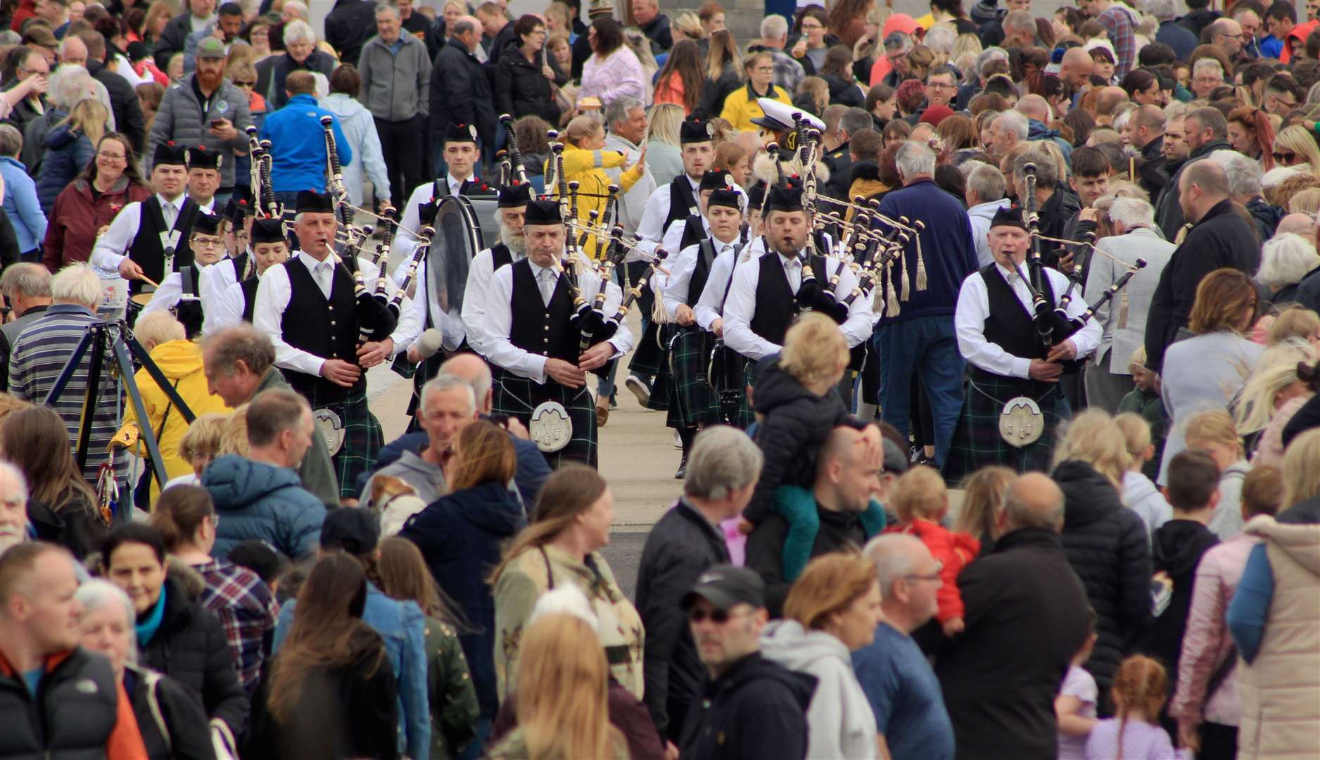 A crowded quayside during a performance by Wick RBLS Pipe Band at last year's event. Picture: Alan Hendry