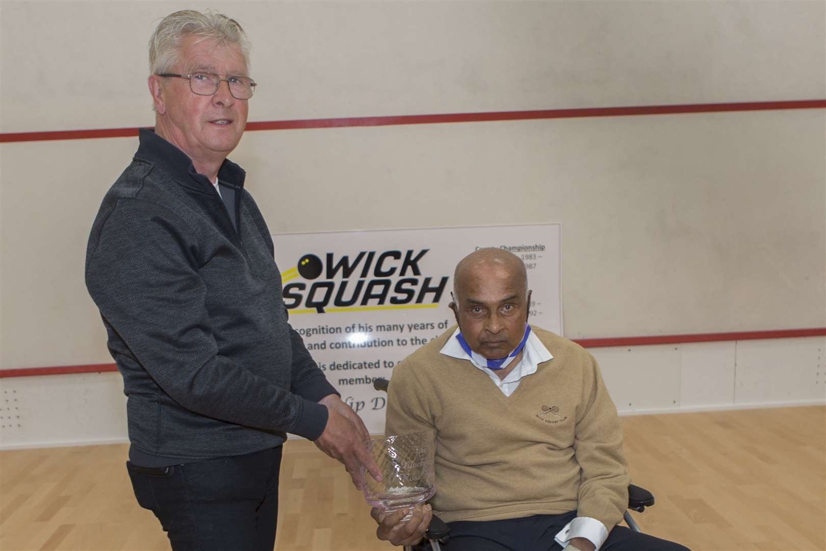 Pradip Datta presents Roy Mackenzie with the Mackenzie Rose Bowl, an engraved glass trophy marking their many years of friendly rivalry in various competitions at Wick Squash Club. Roy has handed the trophy over to the club where it will be competed for annually as a league trophy. Picture: Robert Macdonald / Northern Studios
