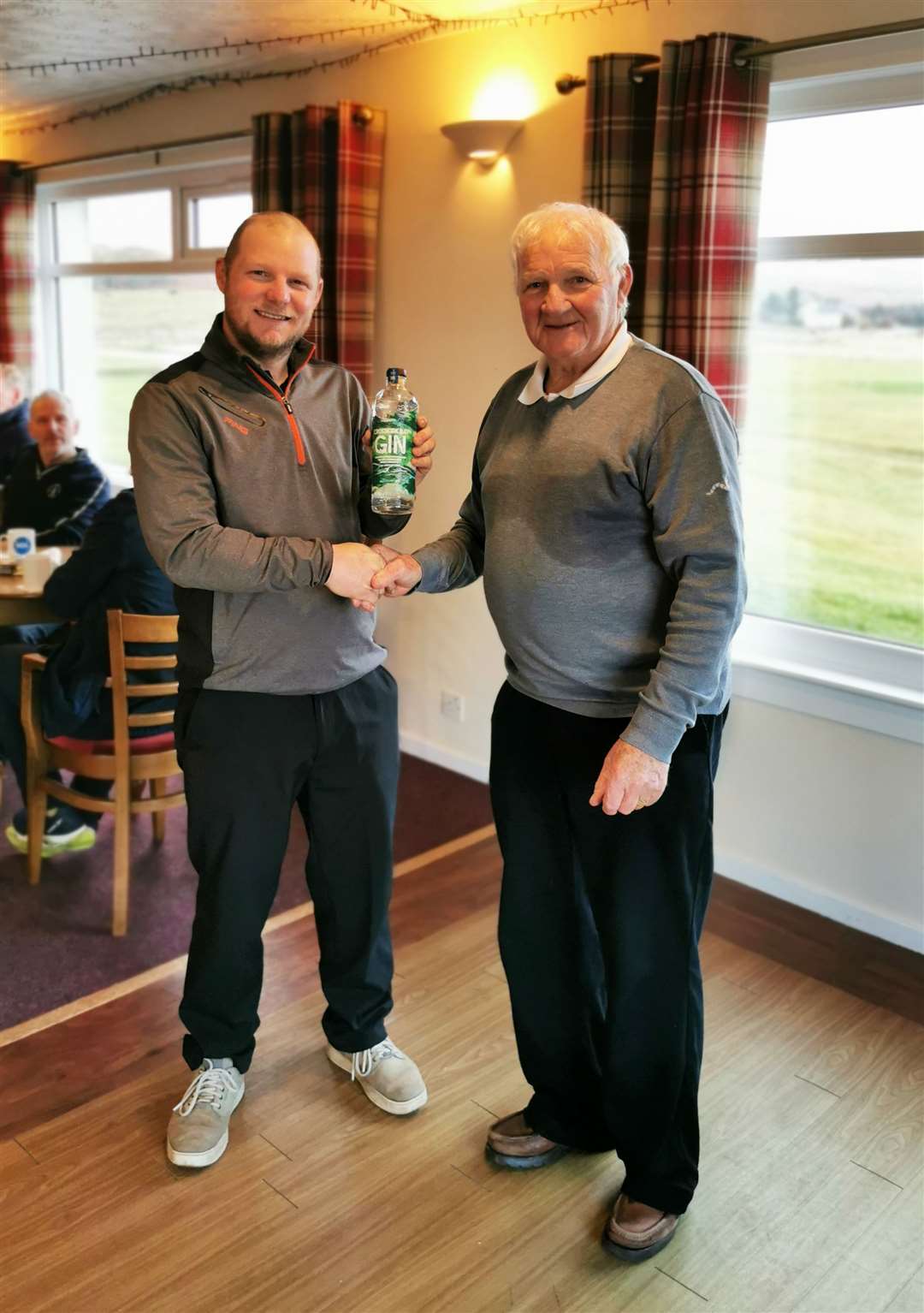 Reay greenkeeper Jason Norwood (left), winner of a bottle of gin courtesy of North Point Distillery at the recent Senior Stableford competition, receiving his prize from Kenny Farmer Snr. Norwood was competing as a ‘guest senior’.