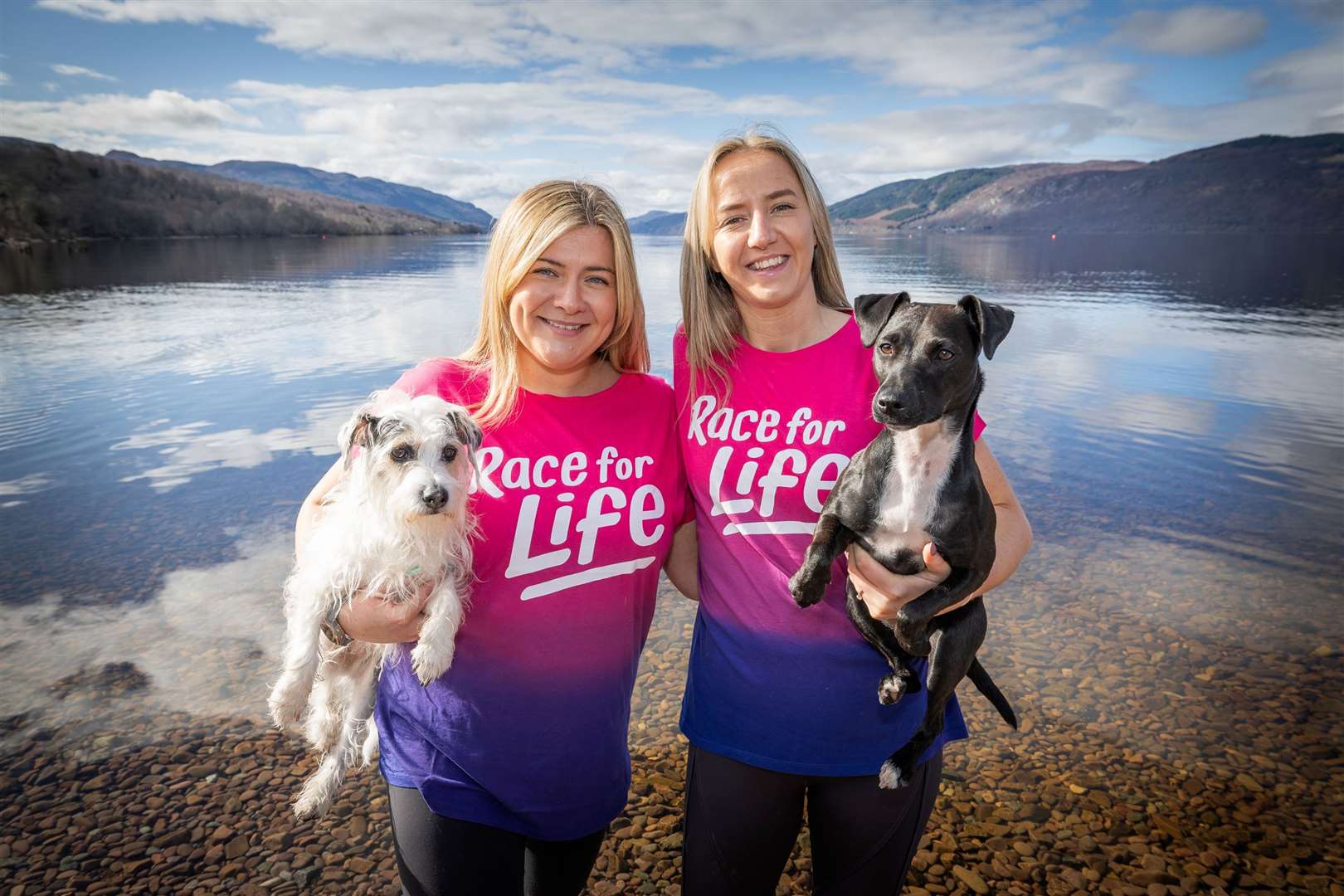 Evie Morrison (left) and wife Kayleigh Deane with their rescue dogs Arlo and Dash at Loch Ness. Picture: Paul Campbell.