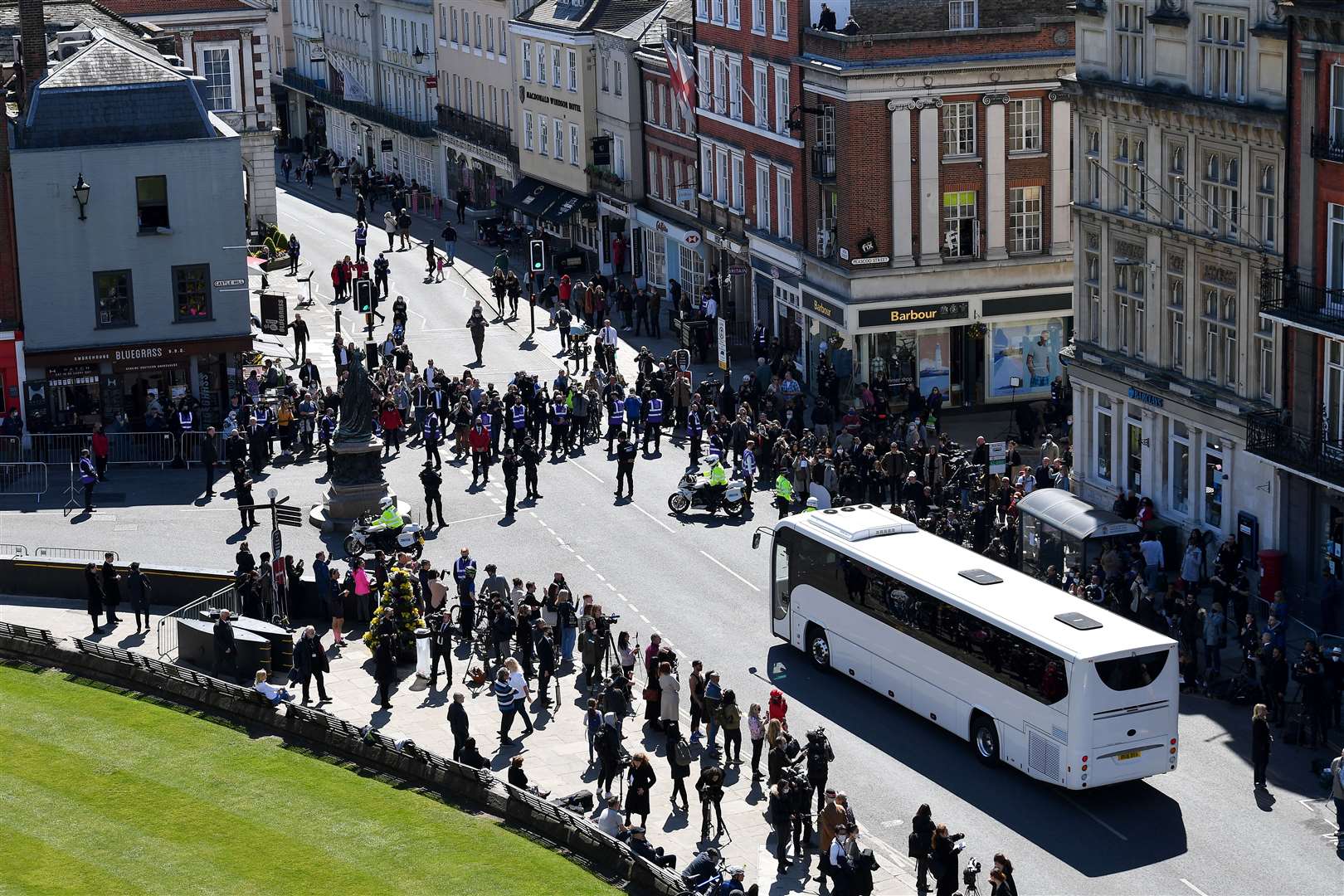 Police hold back the crowds as a coach arrives outside St George’s Chapel (Justin Tallis/PA)