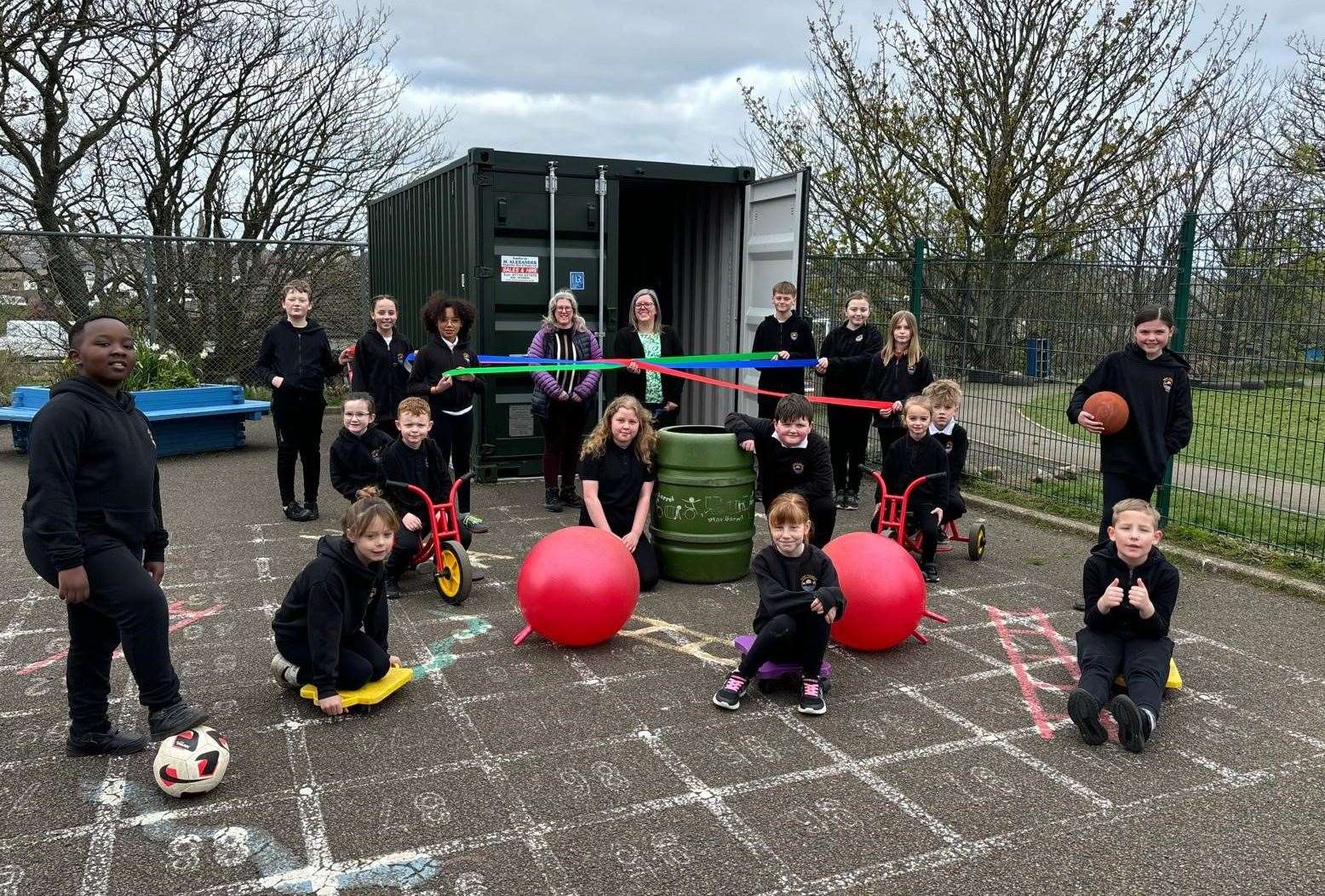 Some pupils from Mount Pleasant Primary School with a selection of their favourite playground toys which are now stored within the new container.