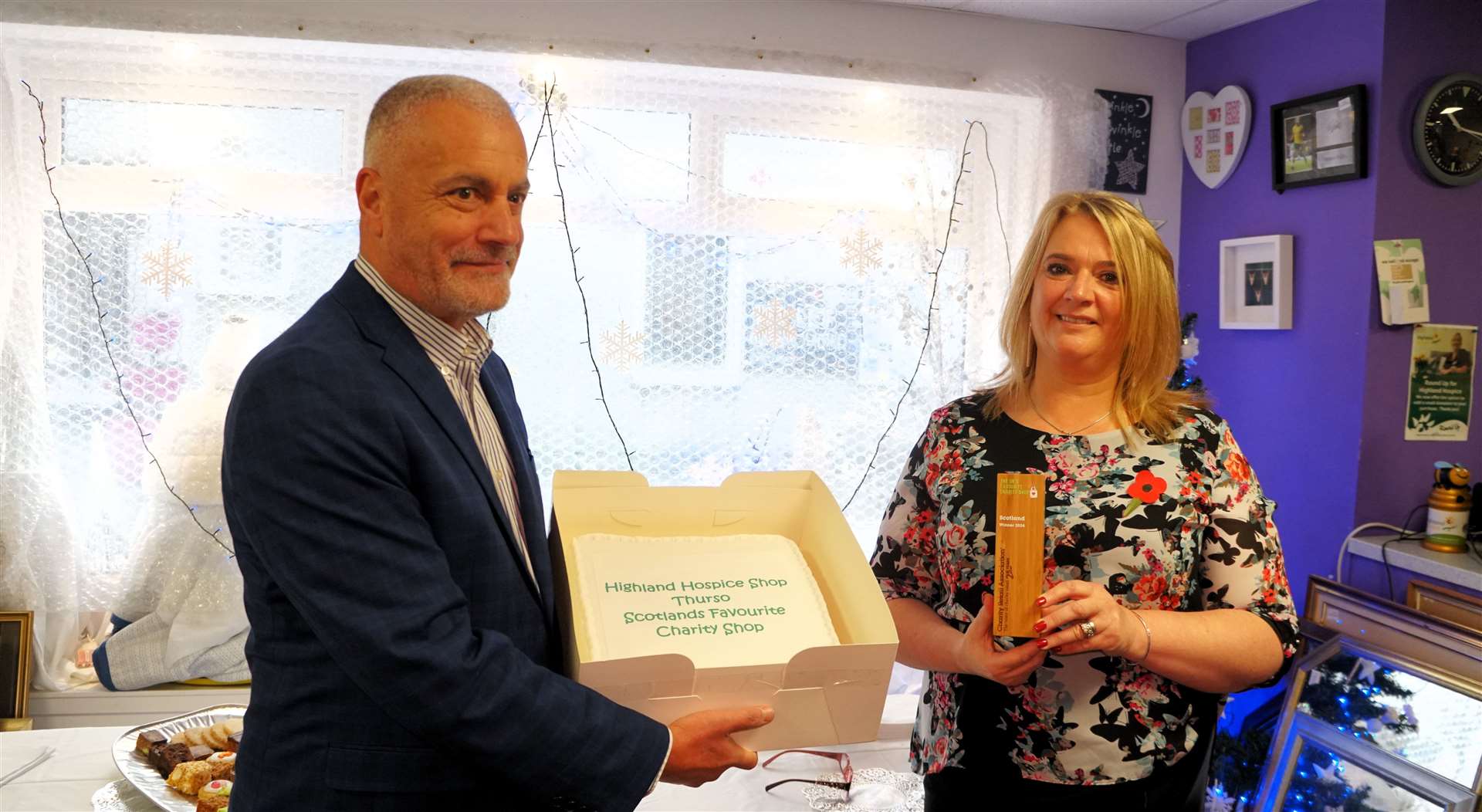 Robin Osterley from the Charity Retail Association, also gave a special cake to Susan Imlach, manager of Highland Hospice's Thurso branch. Picture: DGS
