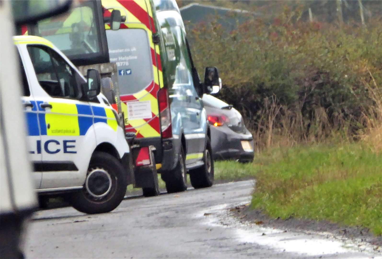 Scene at the crash site on the A882 with police in attendance.
