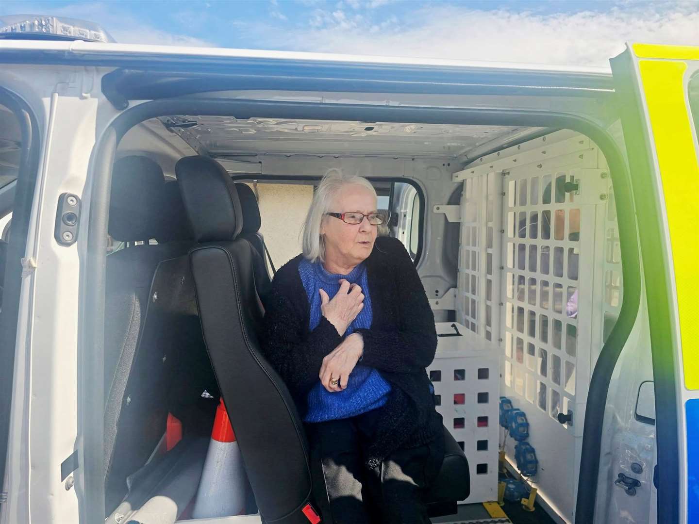 Sandra Thomson pretending she has been arrested in the back of the police van!