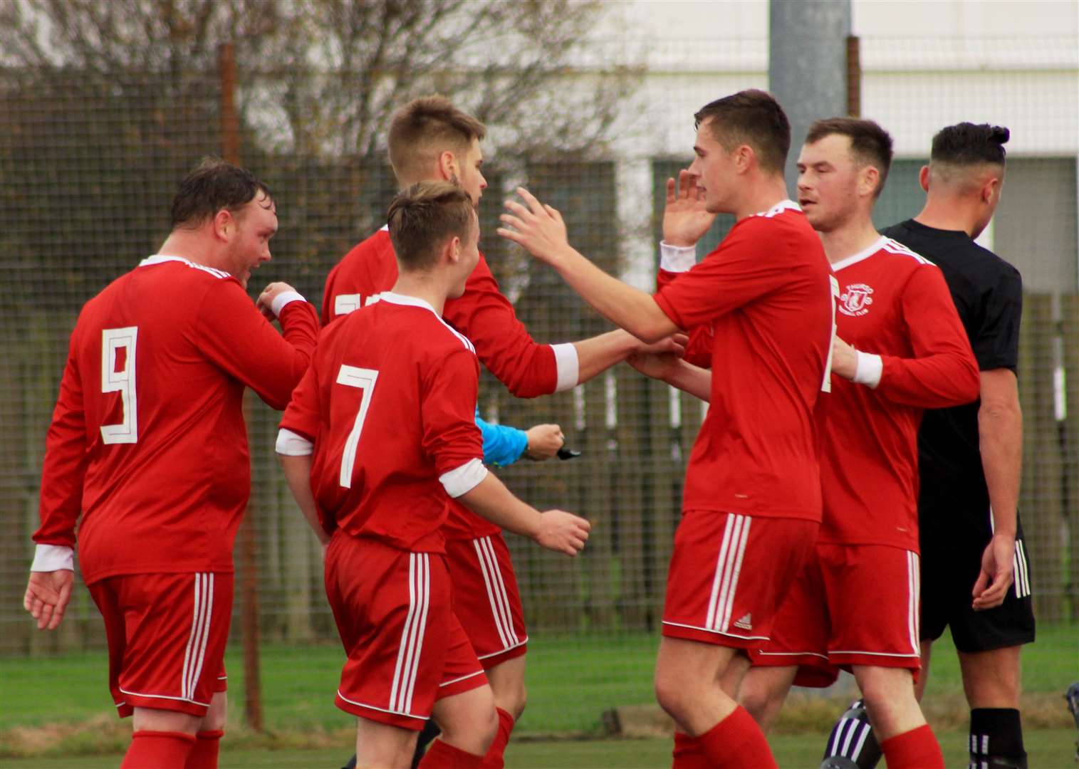 Thurso players congratulate Marc Macgregor after his spot-kick against Invergordon last weekend. Picture: Alan Hendry