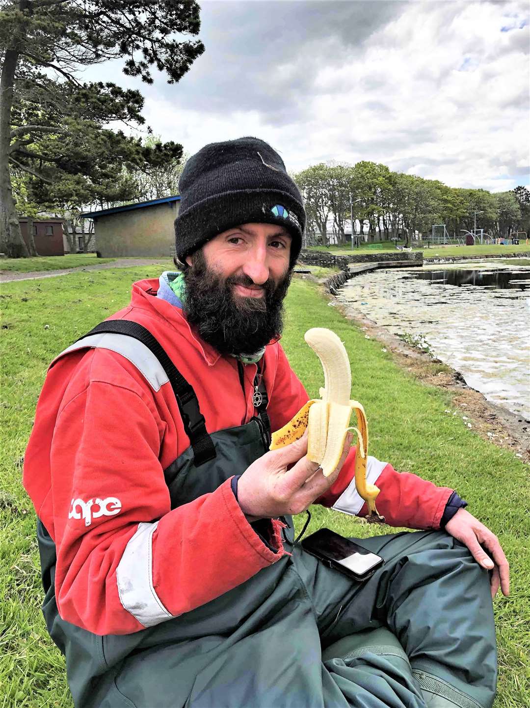 Alexander Glasgow has a snack after helping clear Thurso's boating pond recently. 'People might think I'm bananas but there is a method to it all.' Picture: A Glasgow