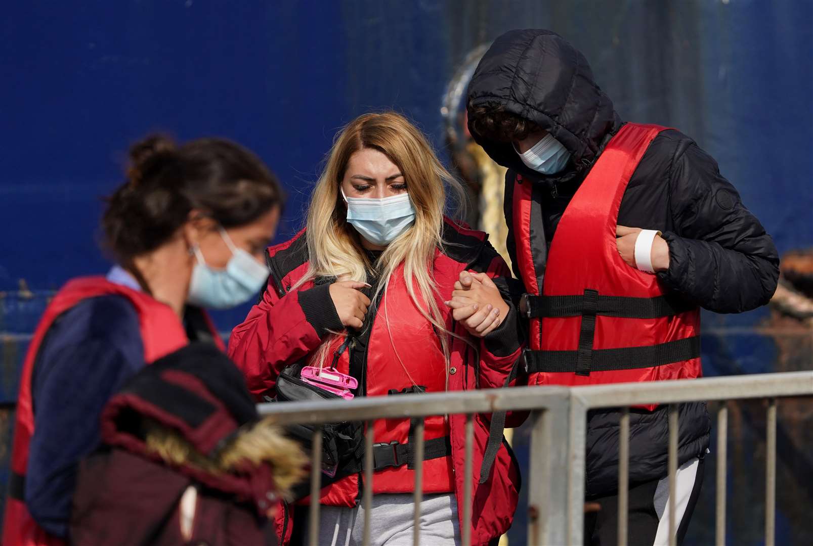 A group thought to be migrants are brought in to Dover from a Border Force vessel (Gareth Fuller/PA)