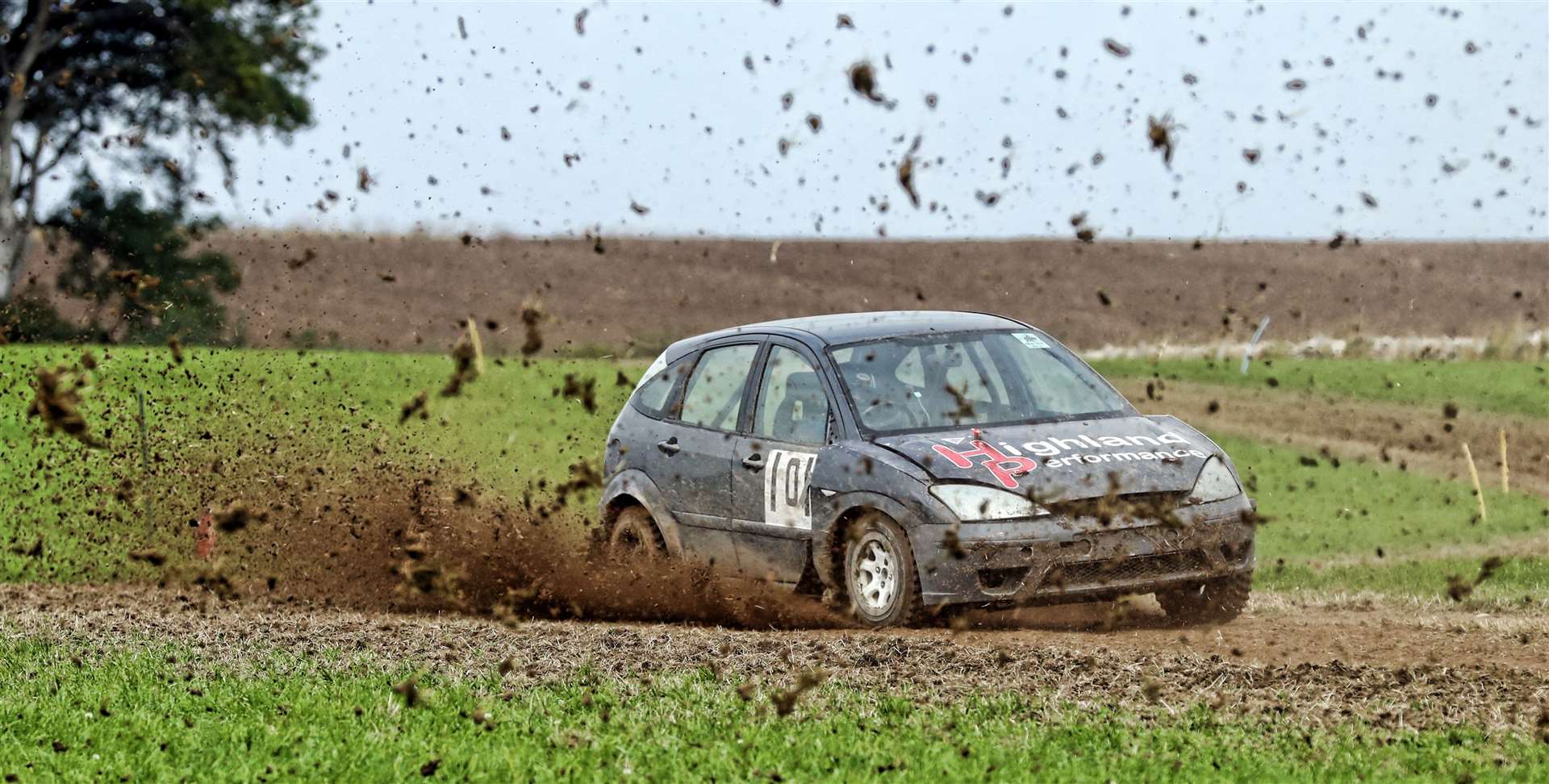 George Coghill Jnr battles his way through a spray of mud in his Ford Focus during a earlier round. Picture: James Gunn