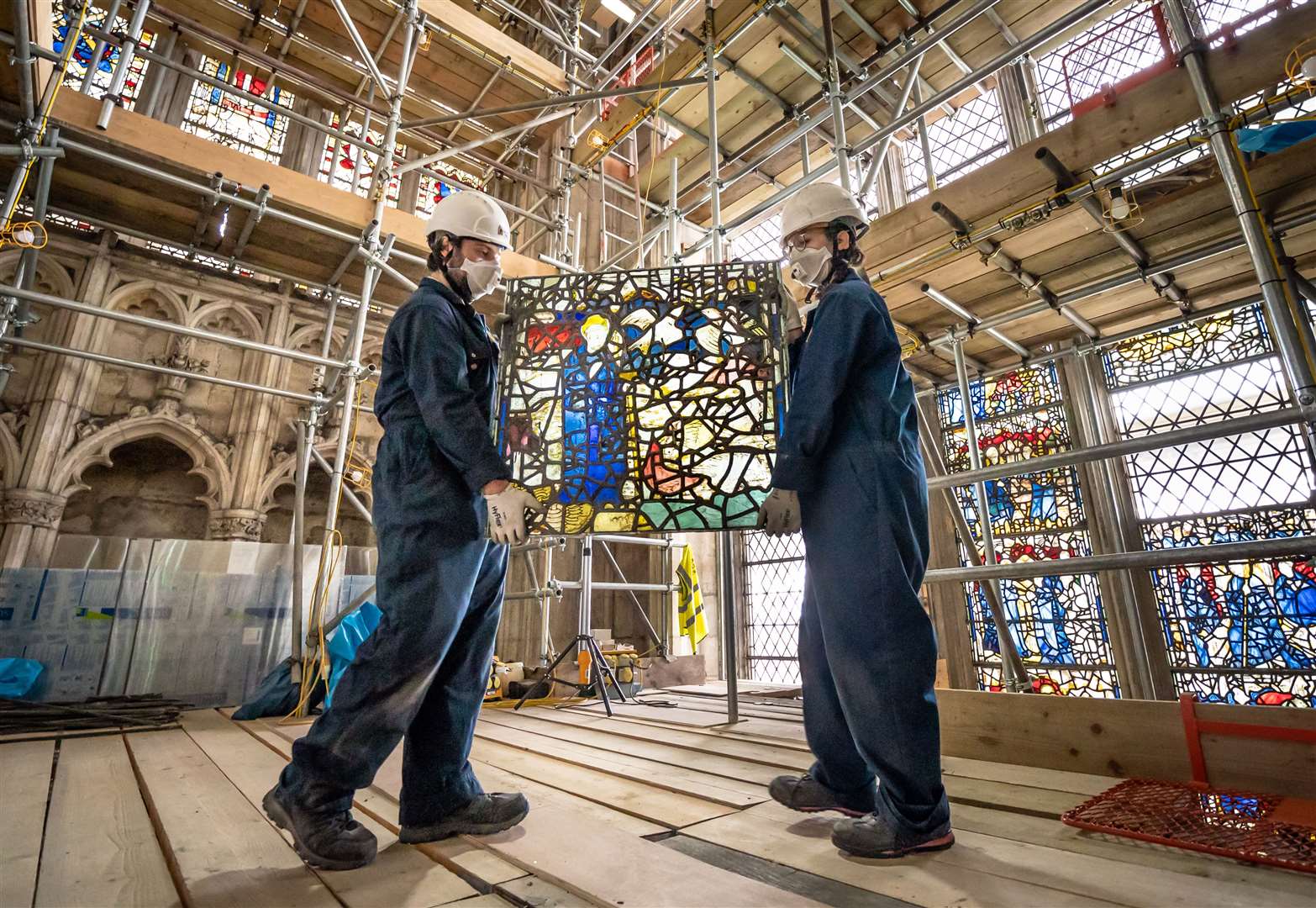 York Glaziers Trust employees Kieran Muir (left) and Emily Price remove a stained glass panel (Danny Lawson/PA)