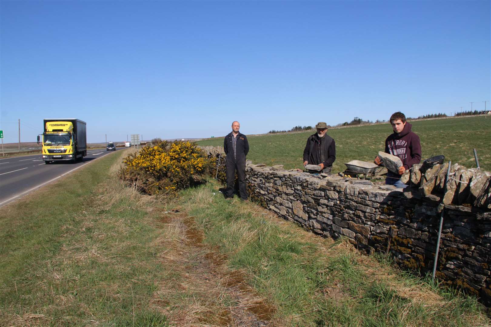 Farmer Christopher Coghill (left) admires the restoration work being carried out by professional stone wall dyker David Henderson (centre) and his son Gordon. Picture: Willie Mackay