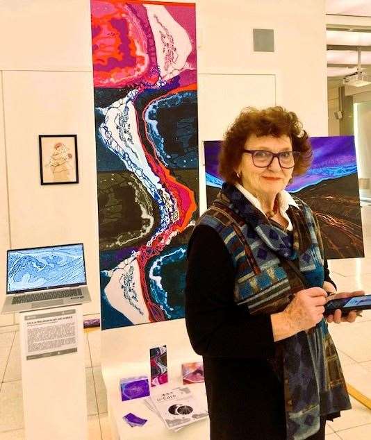 Jenny Bruce with some of the featured paintings at the University of Edinburgh show.